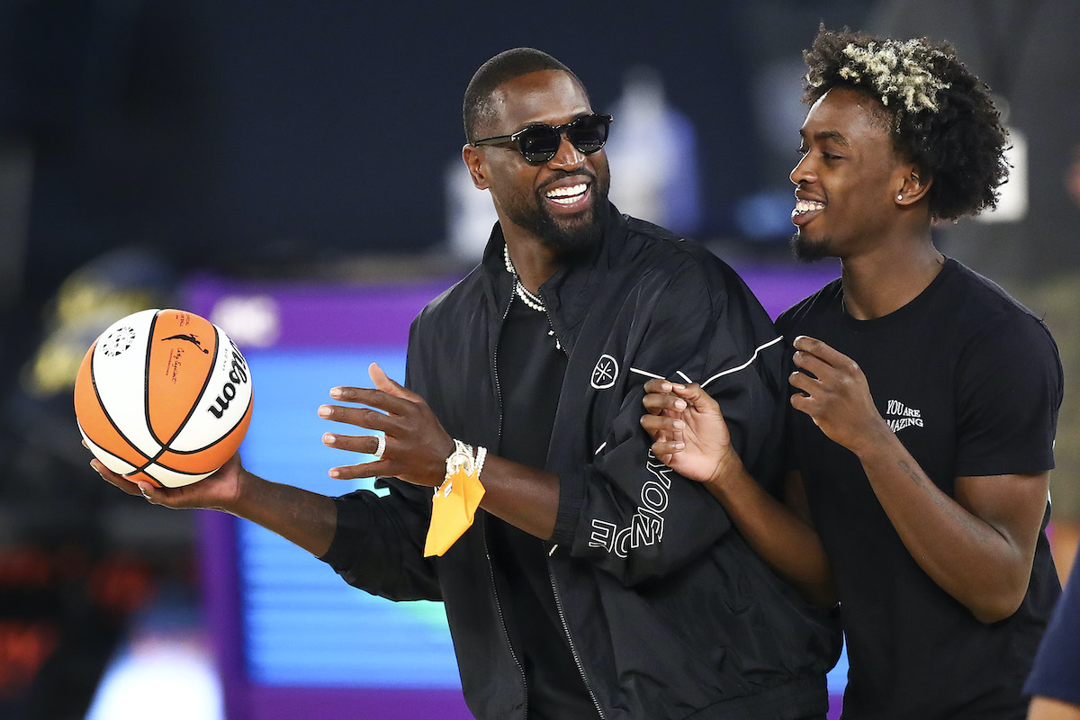 Former NBA player Dwyane Wade and his son Zaire Wade spend time on the court
