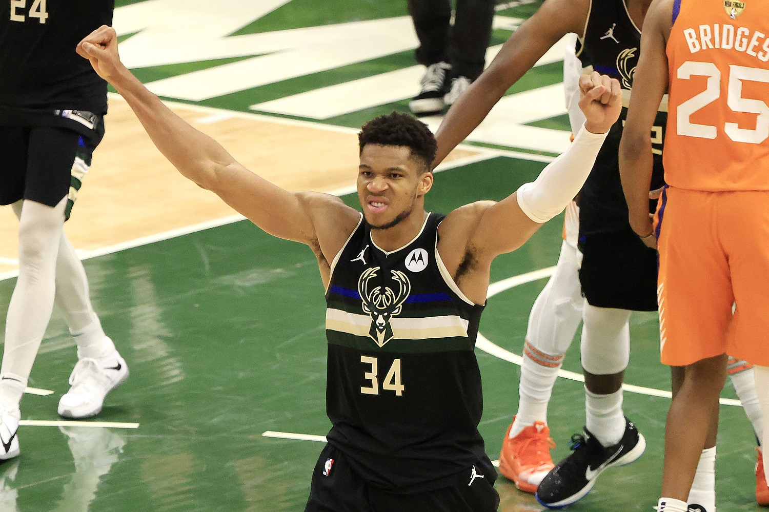 Giannis Antetokounmpo of the Milwaukee Bucks celebrates in the final seconds before defeating the Phoenix Suns in Game 6 to win the 2021 NBA championship at Fiserv Forum.
