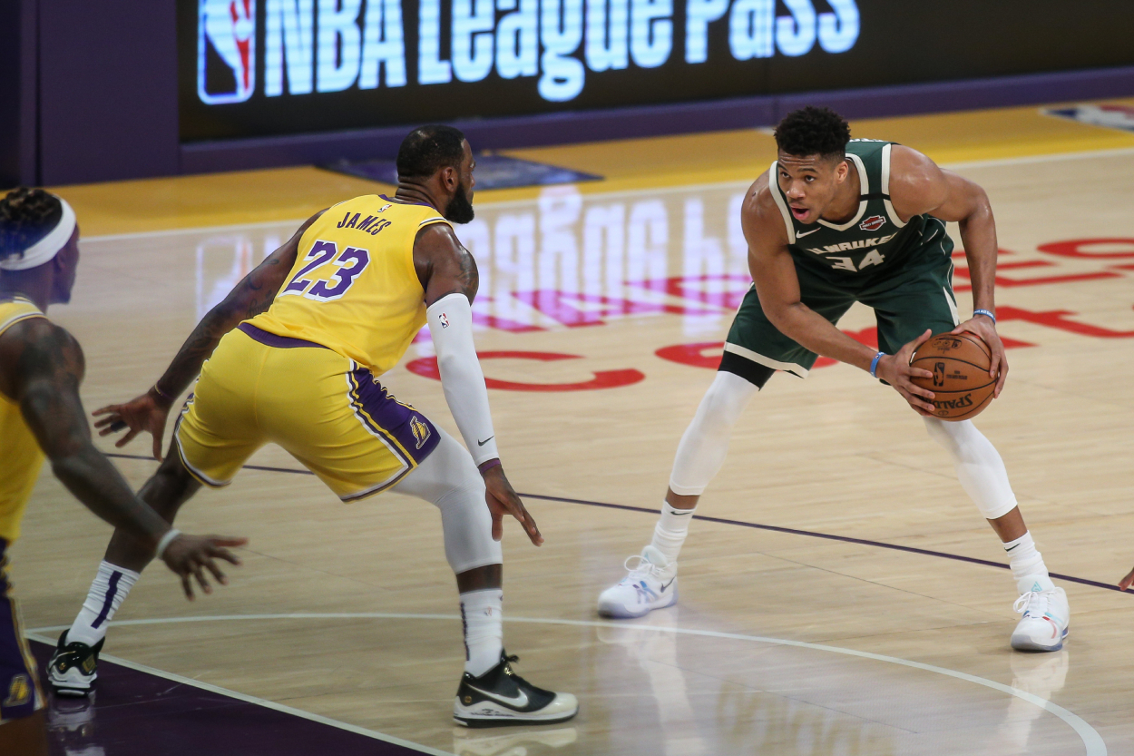 Milwaukee Bucks forward Giannis Antetokounmpo (34) being guarded by Los Angeles Lakers forward LeBron James.