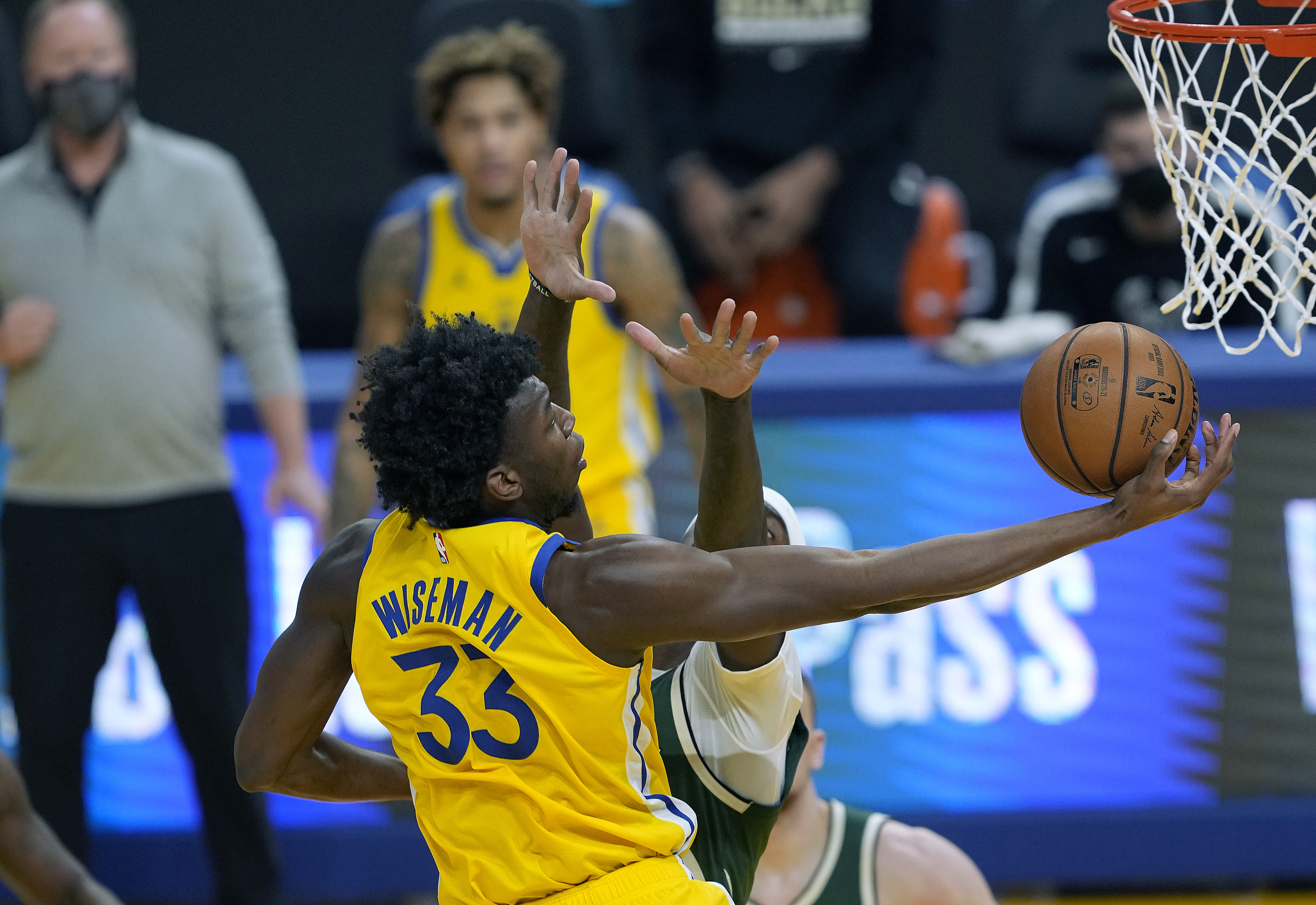 Golden State Warriors center James Wiseman drives to the rim in a game against the Milwaukee Bucks