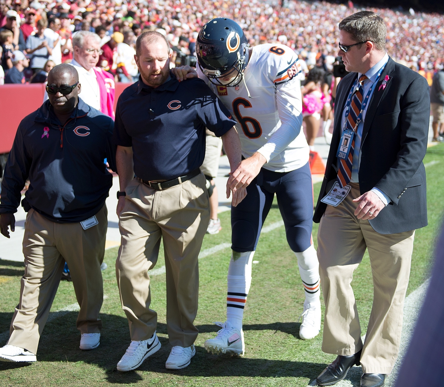 Medical staff assist Chicago Bears quarterback Jay Cutler with leaving the field.