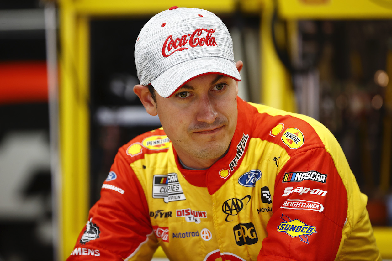 Joey Logano sits in garage