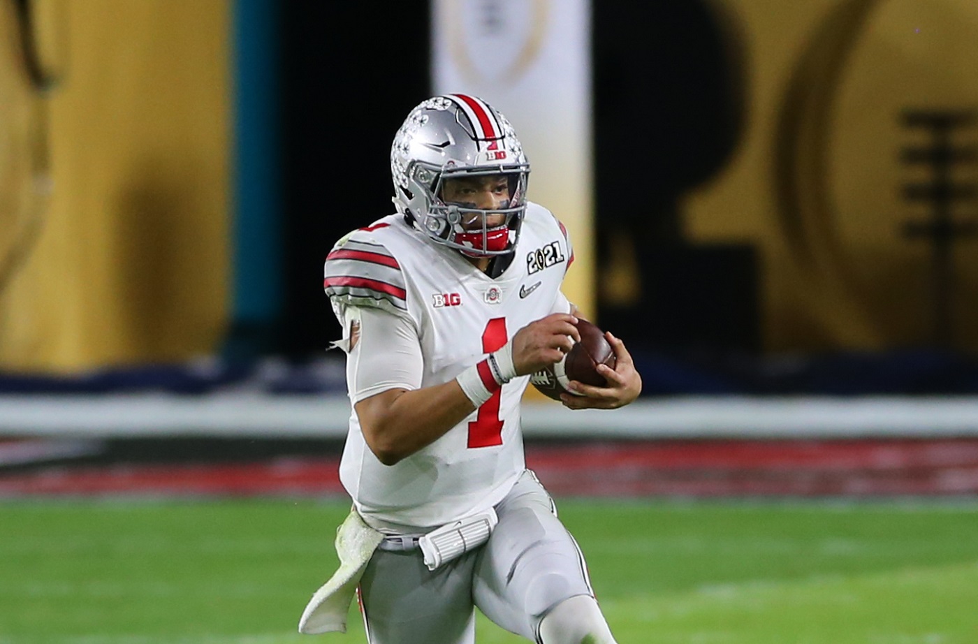 Ohio State Buckeyes quarterback Justin Fields runs with the ball against Alabama on Jan. 11, 2021, at Hard Rock Stadium in Miami Gardens, Florida.