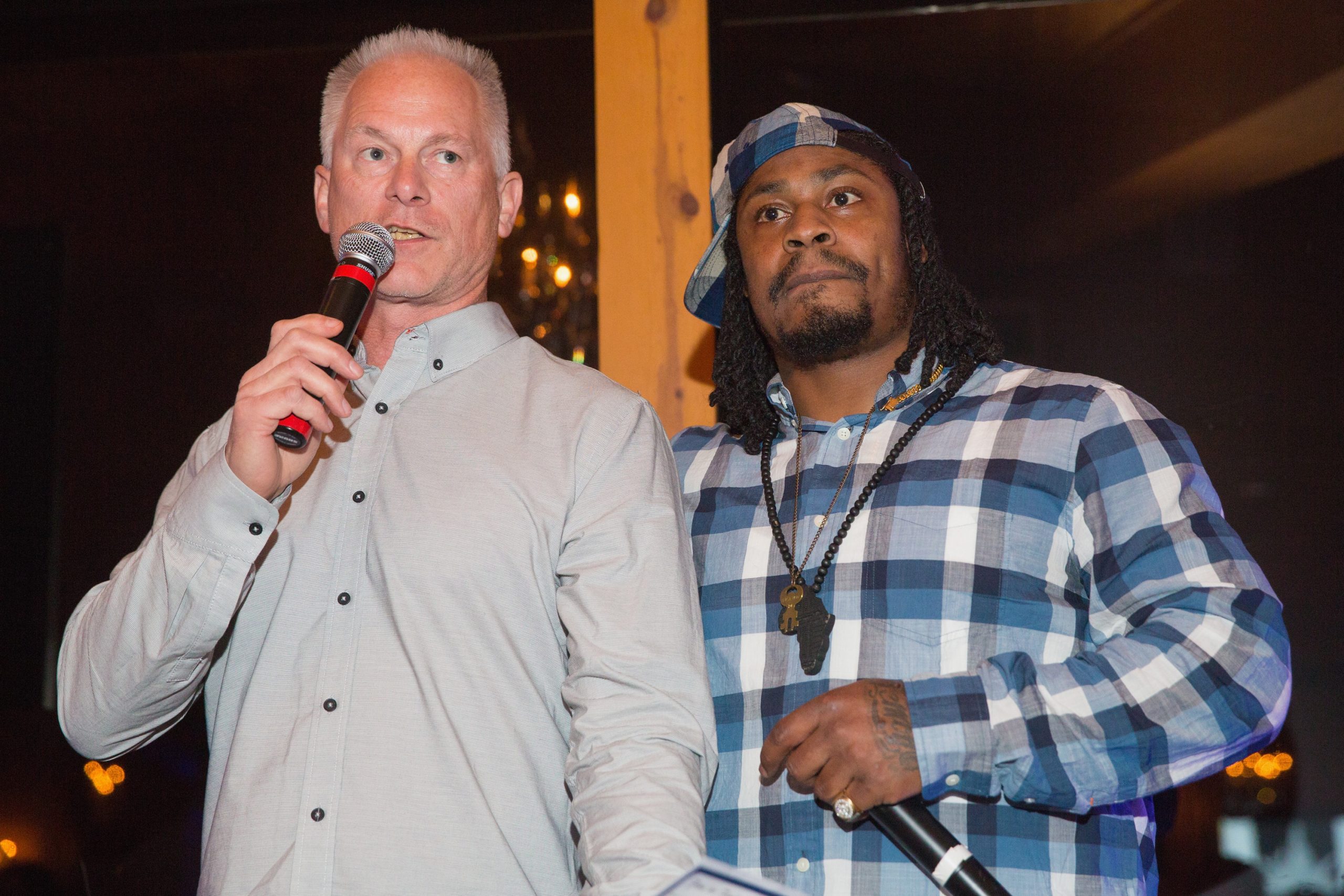 Kenny Mayne (L) and Marshawn Lynch speak during the FAM 1st FAMILY FOUNDATION Charity Event