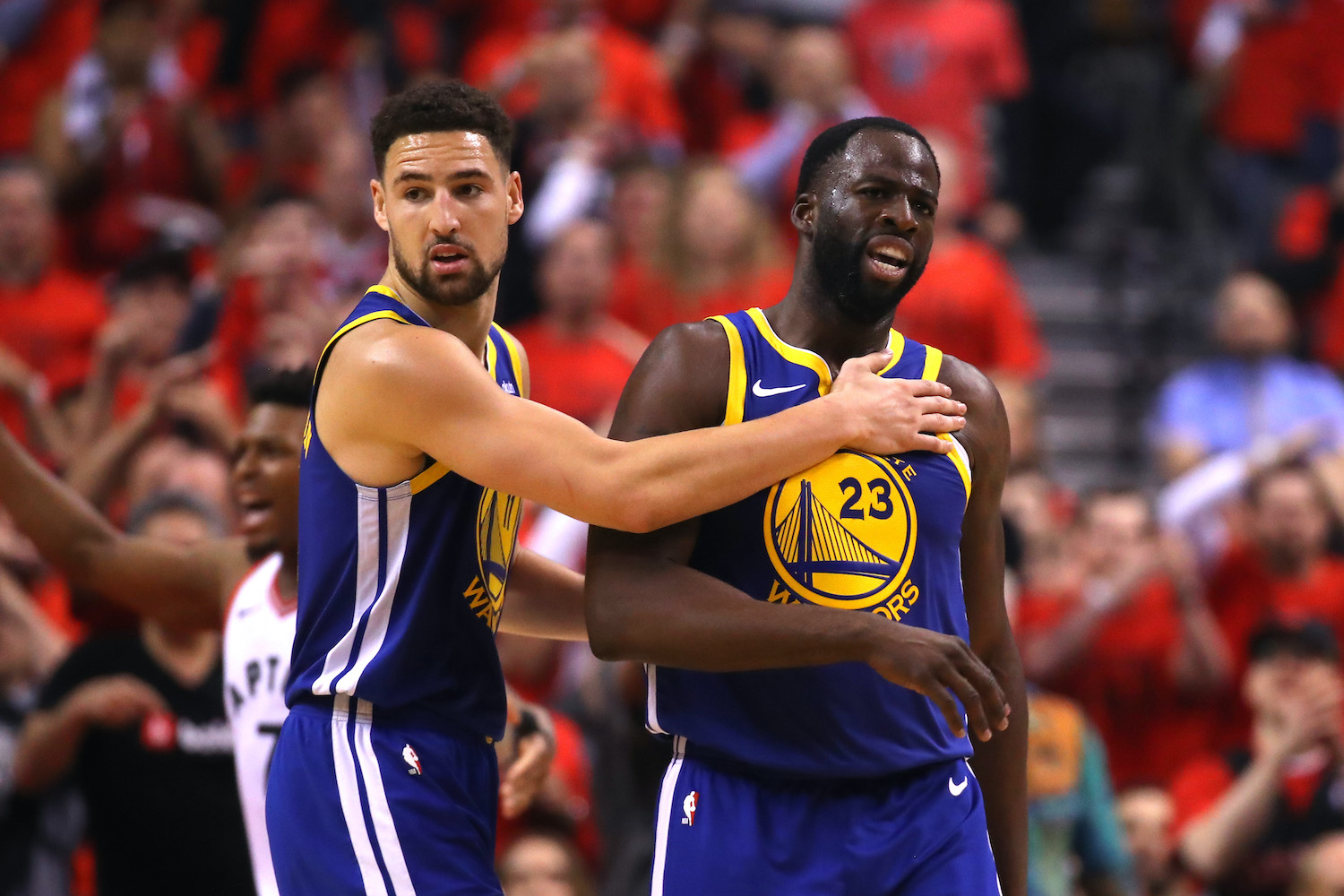 Golden State Warriors guard Klay Thompson holds Draymond Green during the 2019 NBA Finals.