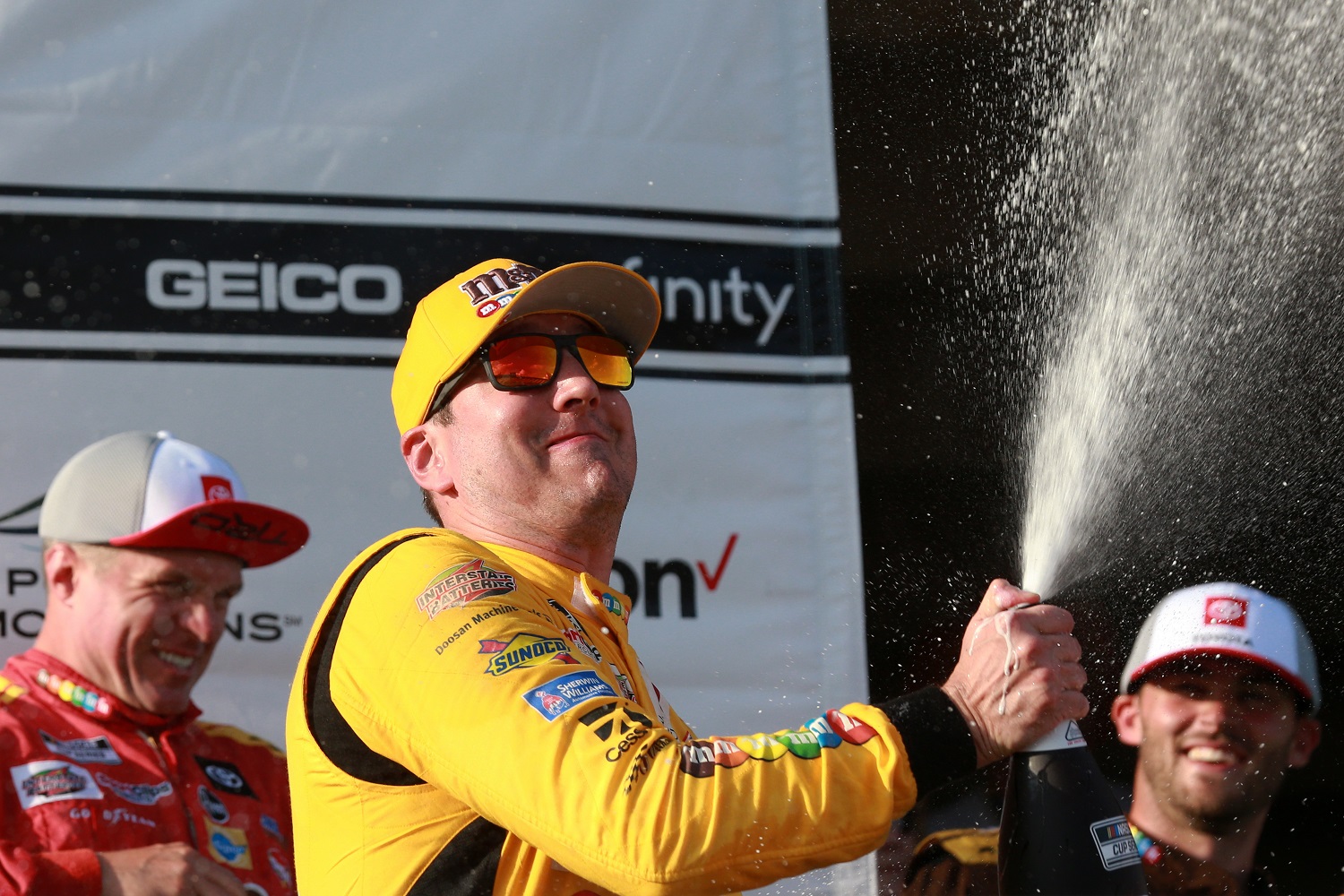 Kyle Busch, driver of the Joe Gibbs Racing No. 18 Toyota, celebrates in victory lane after winning the NASCAR Cup Series Explore the Pocono Mountains 350 at Pocono Raceway. | Sean Gardner/Getty Images