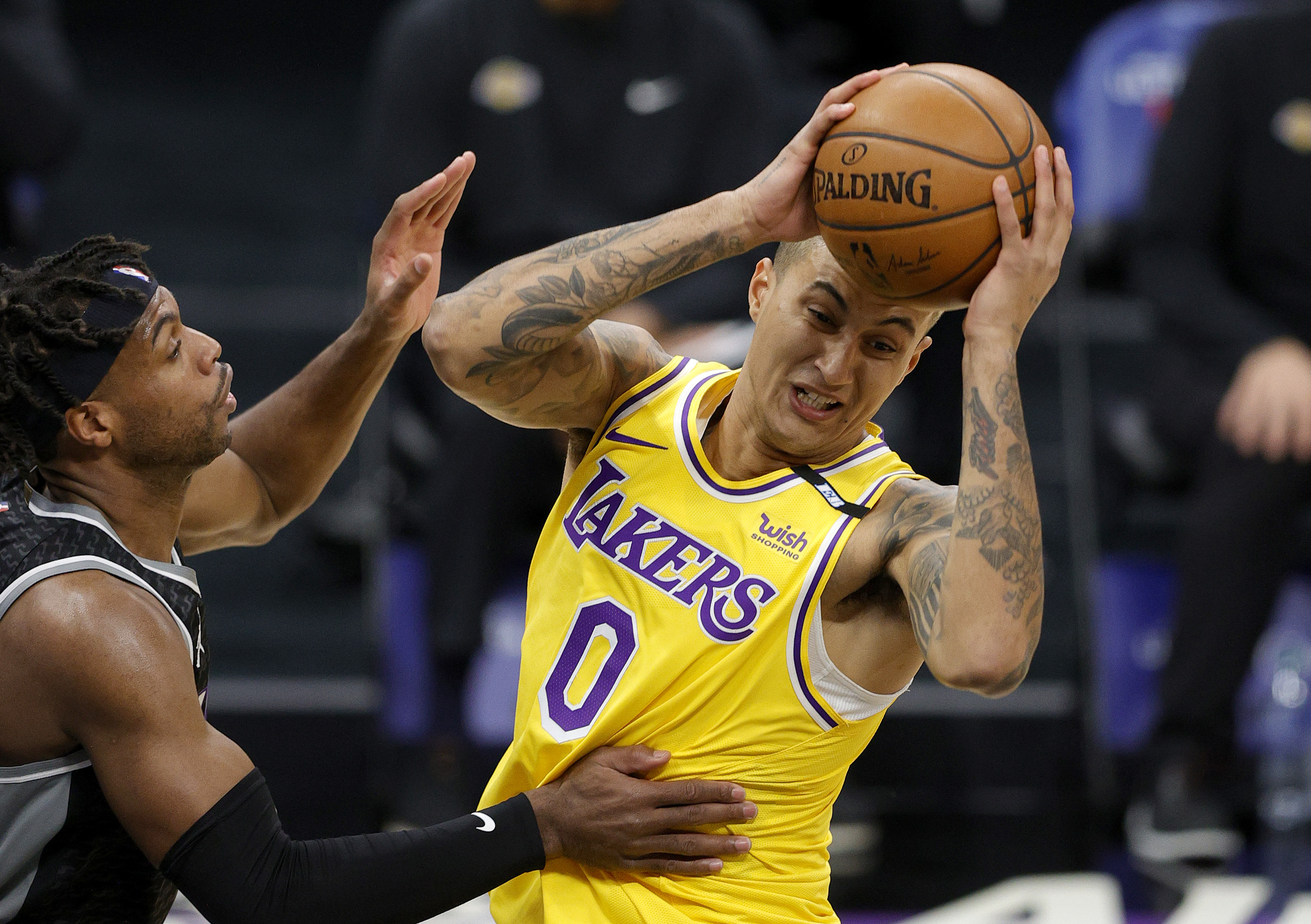 Kings guard Buddy Hield defends Lakers forward Kyle Kuzma during a game in April