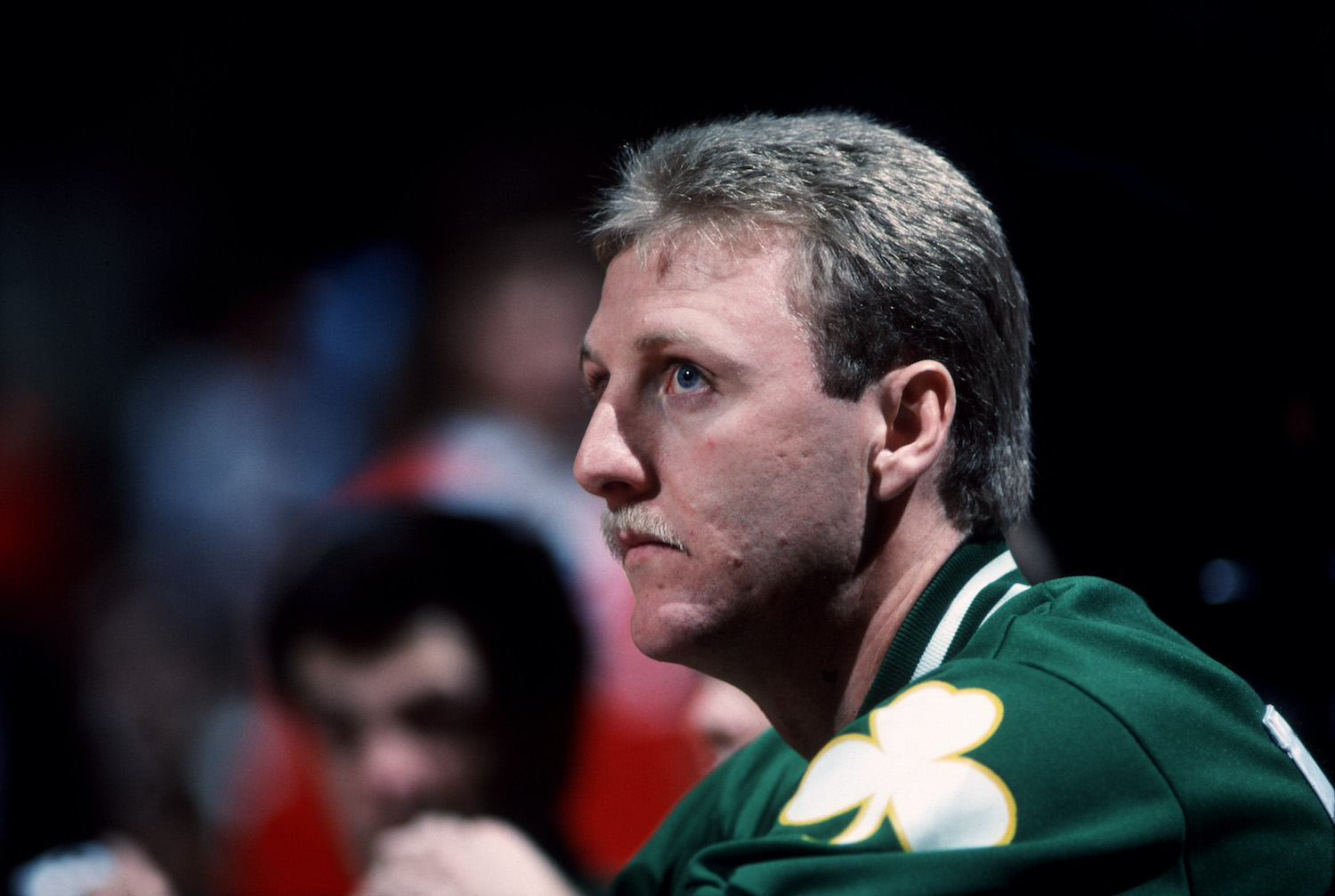 Boston Celtics legend Larry Bird sits on the bench.