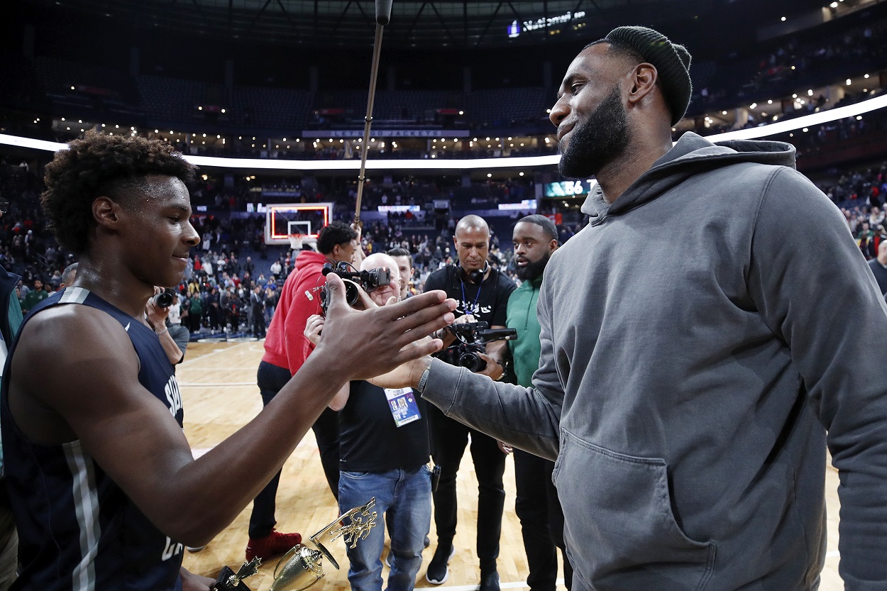 Bronny James and LeBron James following one of Bronny's games in 2019