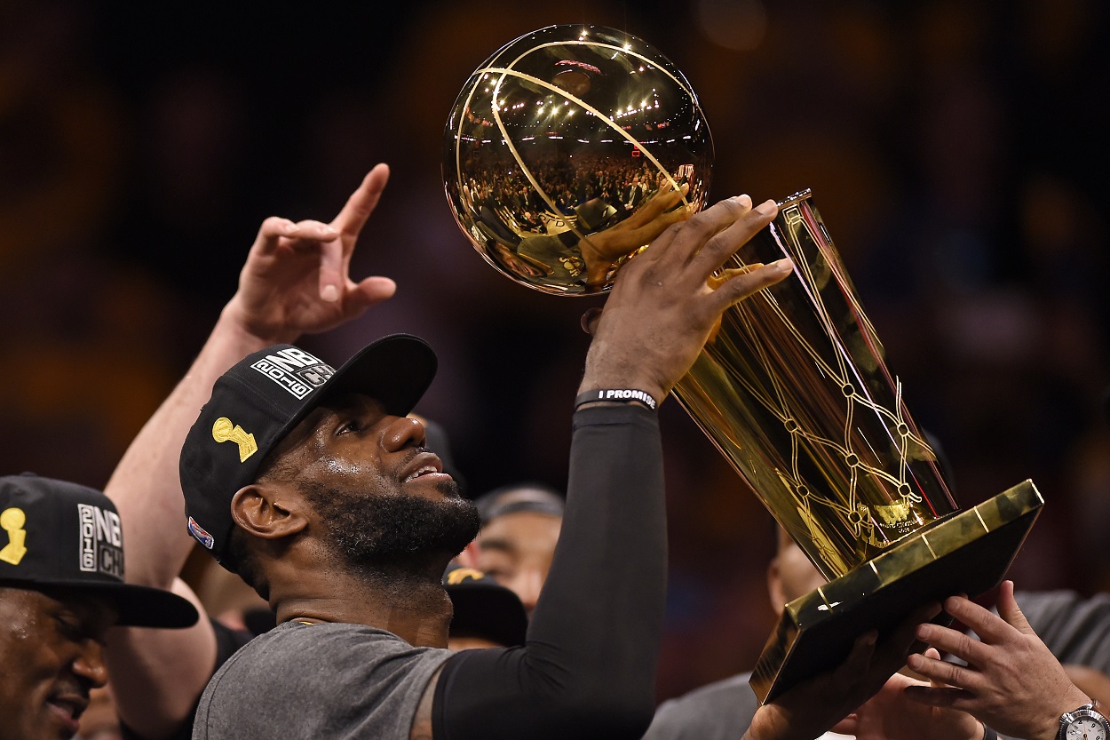 LeBron James holds up the Larry O'Brien trophy after leading the Cavaliers to an NBA championship in 2016
