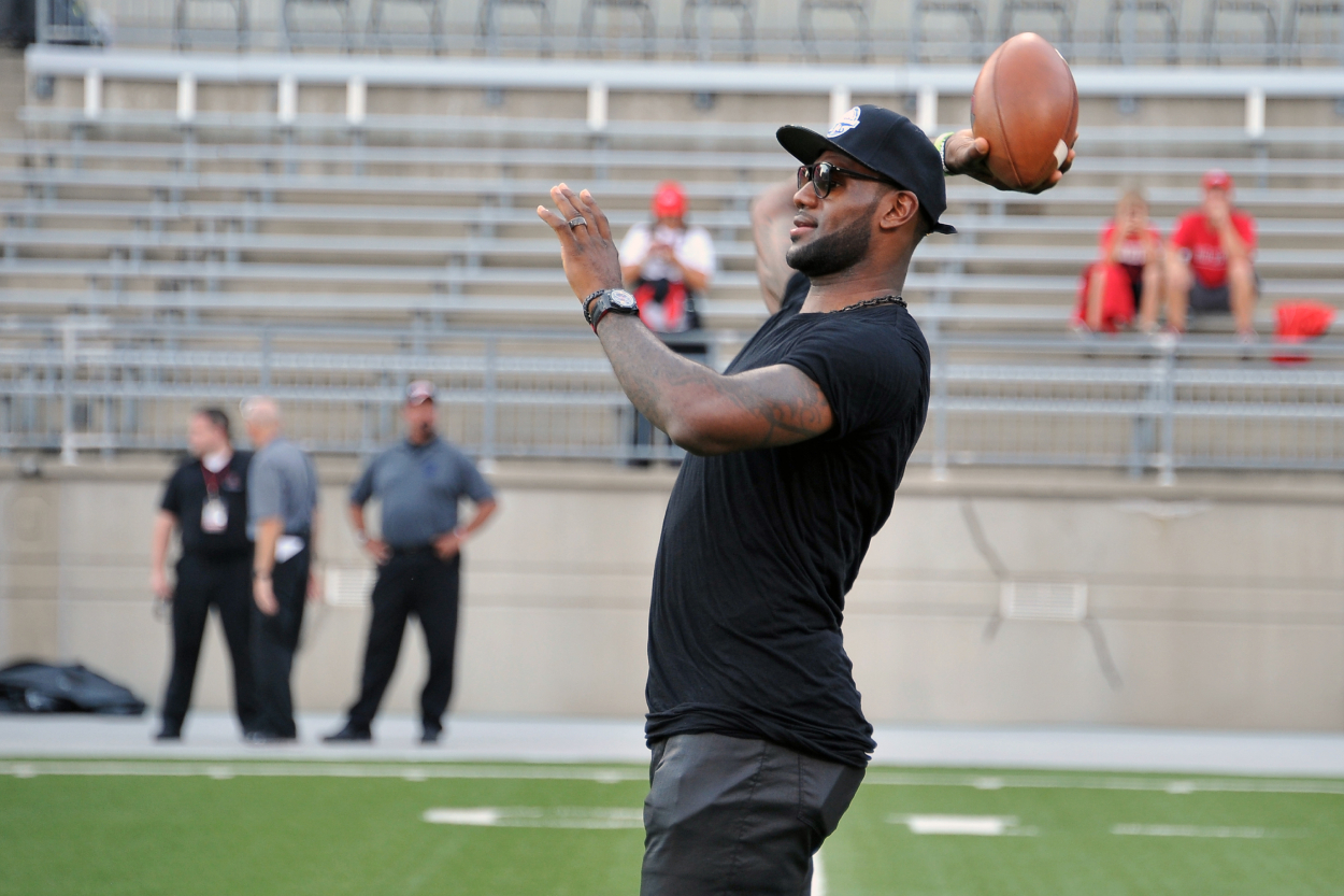 LeBron James throws a football before a Wisconsin vs. Ohio State football game in 2013.