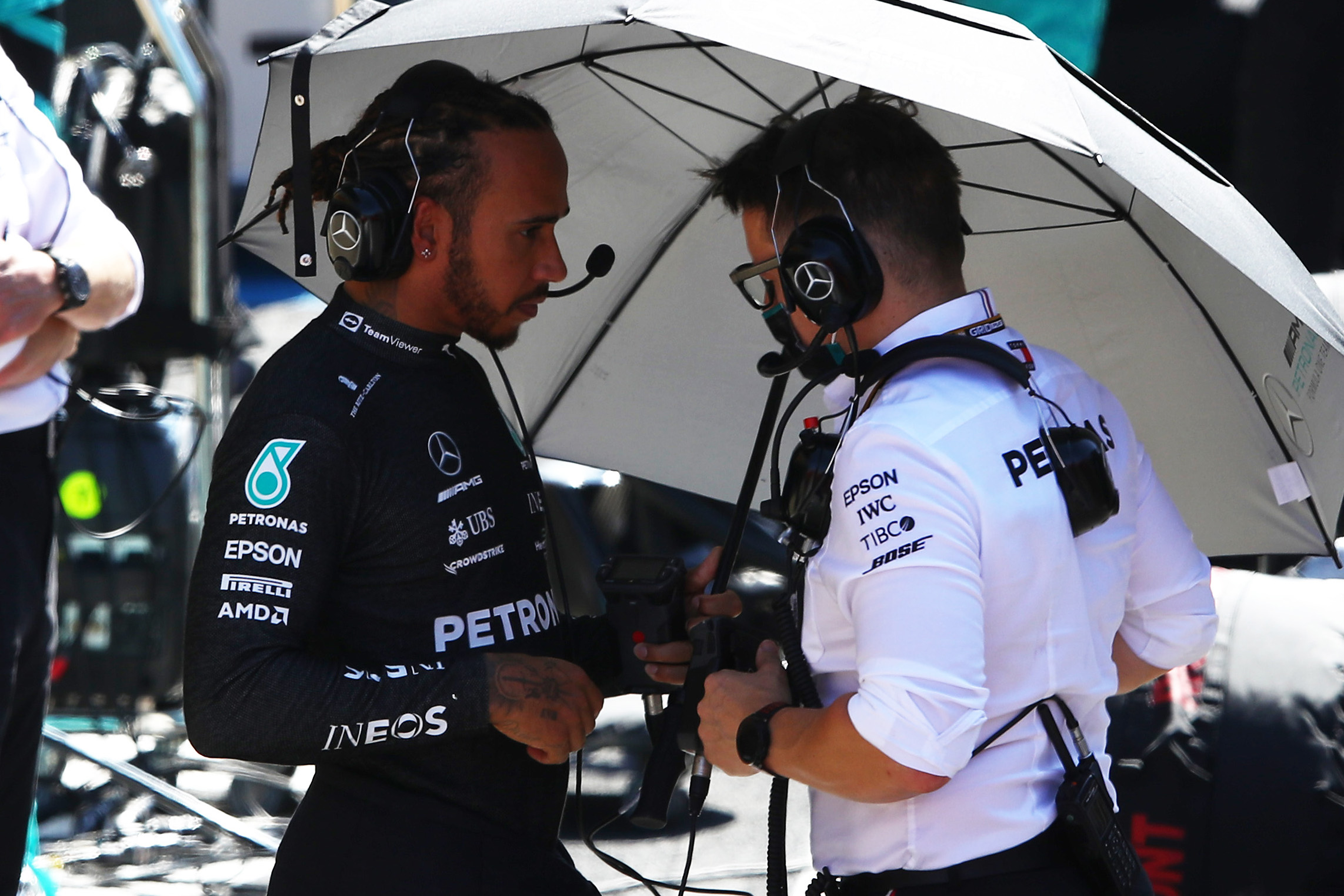Lewis Hamilton of Great Britain and Mercedes GP talks with race engineer Peter Bonnington during the red flag delay during the F1 Grand Prix of Great Britain .
