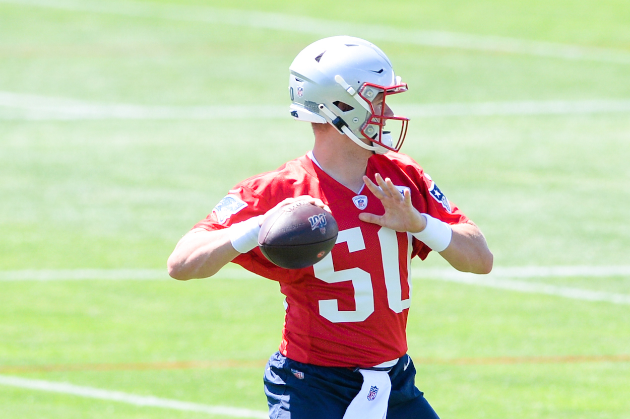 Mac Jones of the New England Patriots looks to complete a pass during mandatory minicamp at the New England Patriots practice facility on June 16, 2021 in Foxborough, Massachusetts.