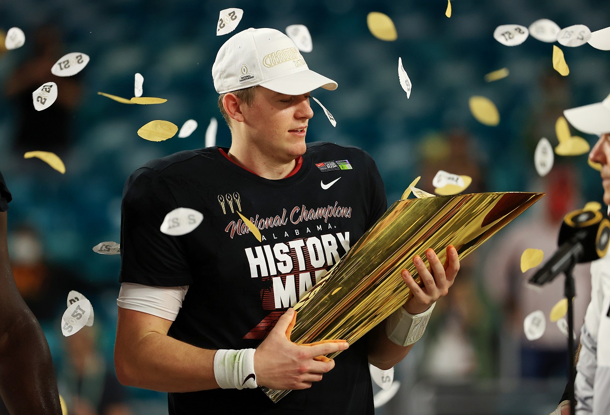 Former Alabama qb Mac Jones holds the national championship trophy after Bama's victory over Ohio State.