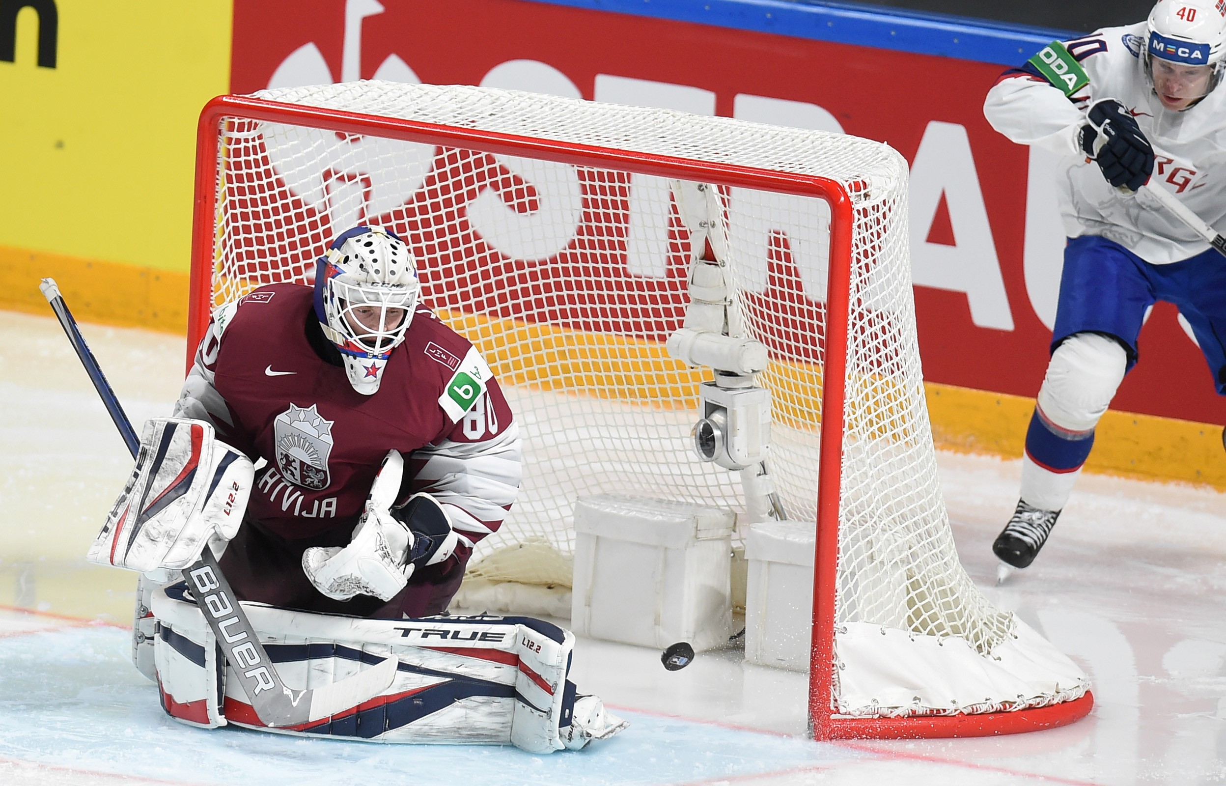 Latvia's goalkeeper Matiss Kivlenieks tries to make a save.