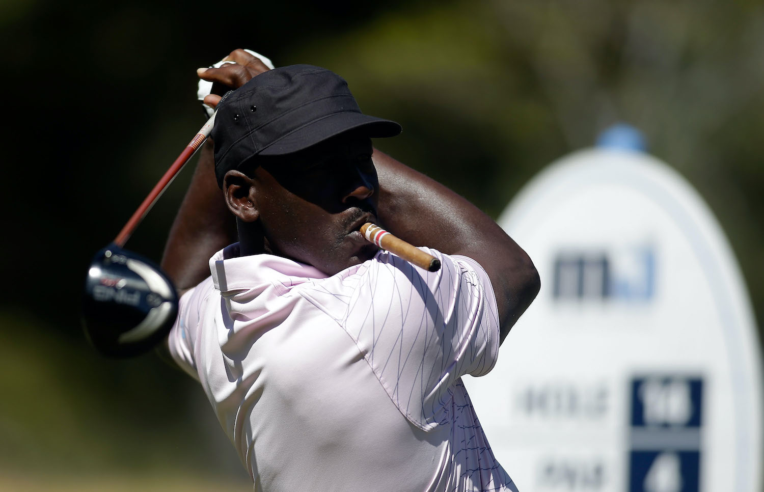 Michael Jordan takes a swing on the golf course.