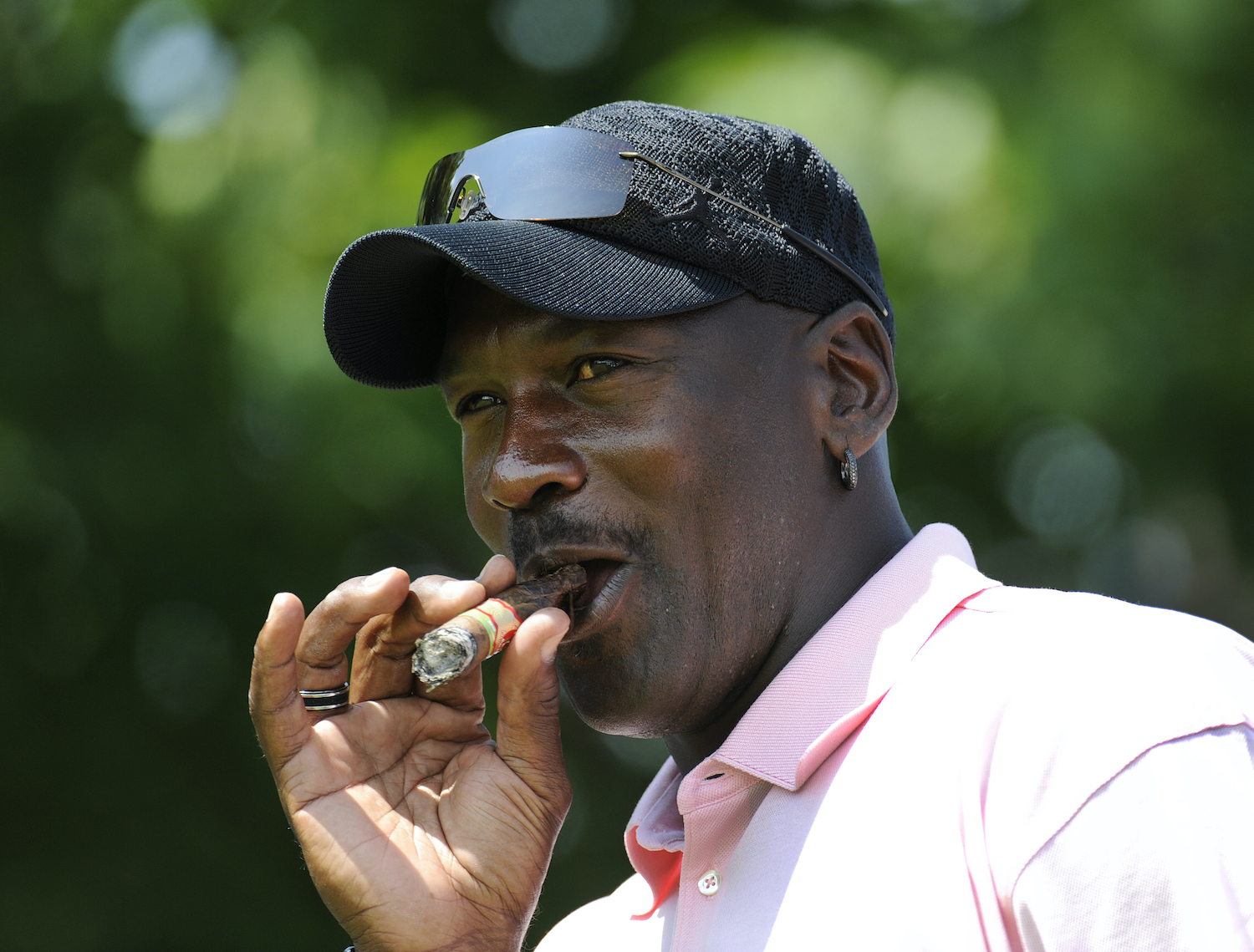 NBA legend Michael Jordan smokes a cigar during a 2009 golf tournament.