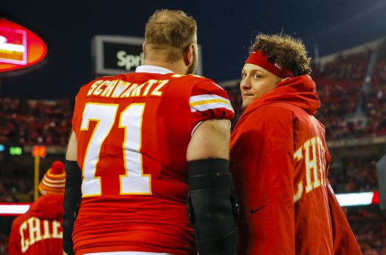 Mitchell Schwartz and Patrick Mahomes stand on the sidelines during a Kansas City Chiefs game.
