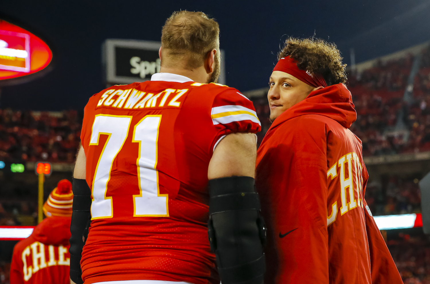 Mitchell Schwartz and Patrick Mahomes stand on the sidelines during a Kansas City Chiefs game.