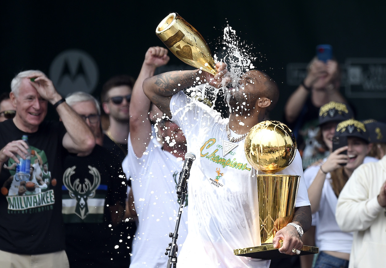 P.J. Tucker celebrates with the Larry O'Brien trophy during the Milwaukee Bucks 2021 NBA Championship Victory Parade and Rally in the Deer District of Fiserv Forum on July 22, 2021 in Milwaukee, Wisconsin.