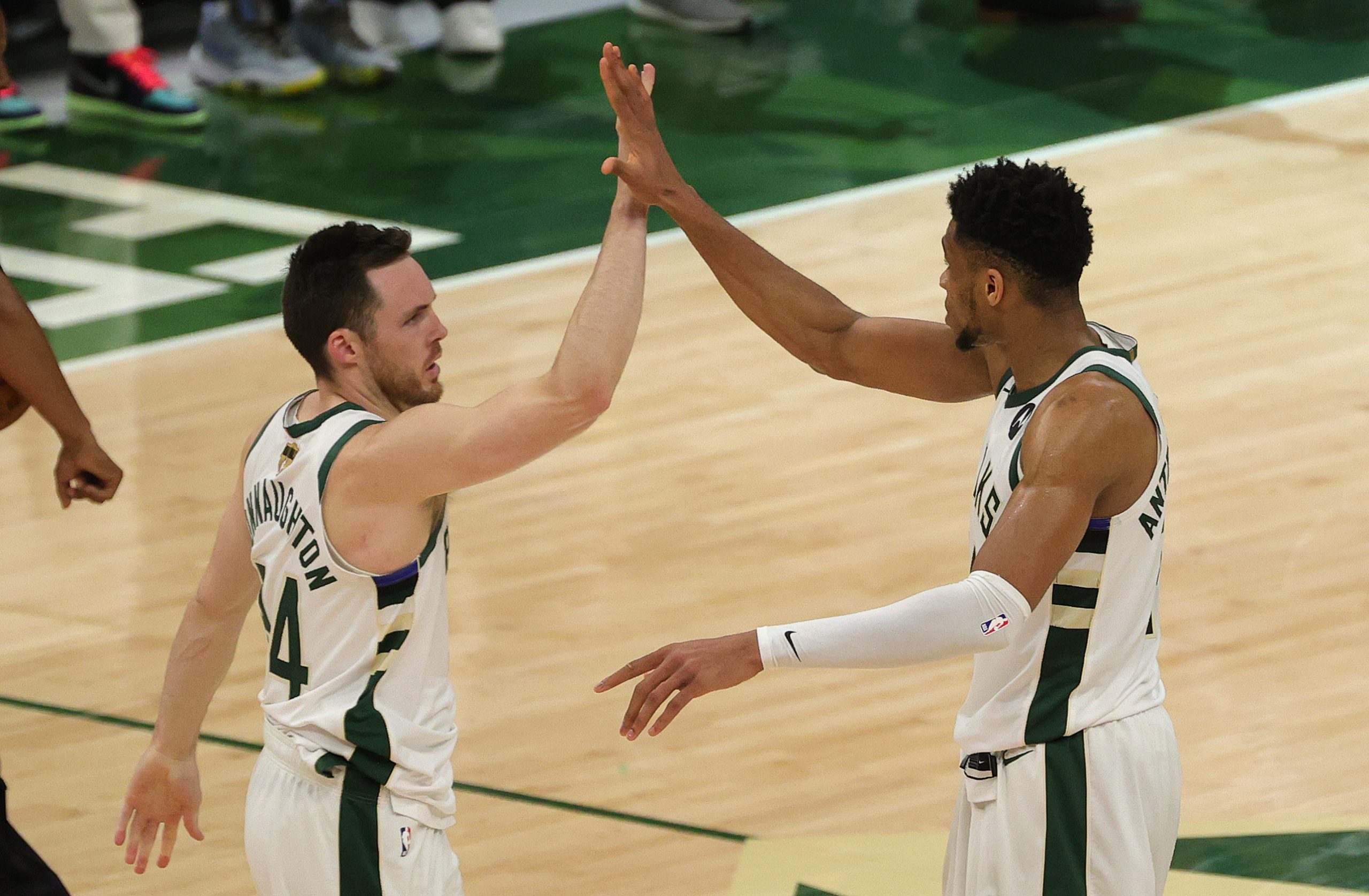 Pat Connaughton high-fives Giannis Antetokounmpo after a Game 4 win.