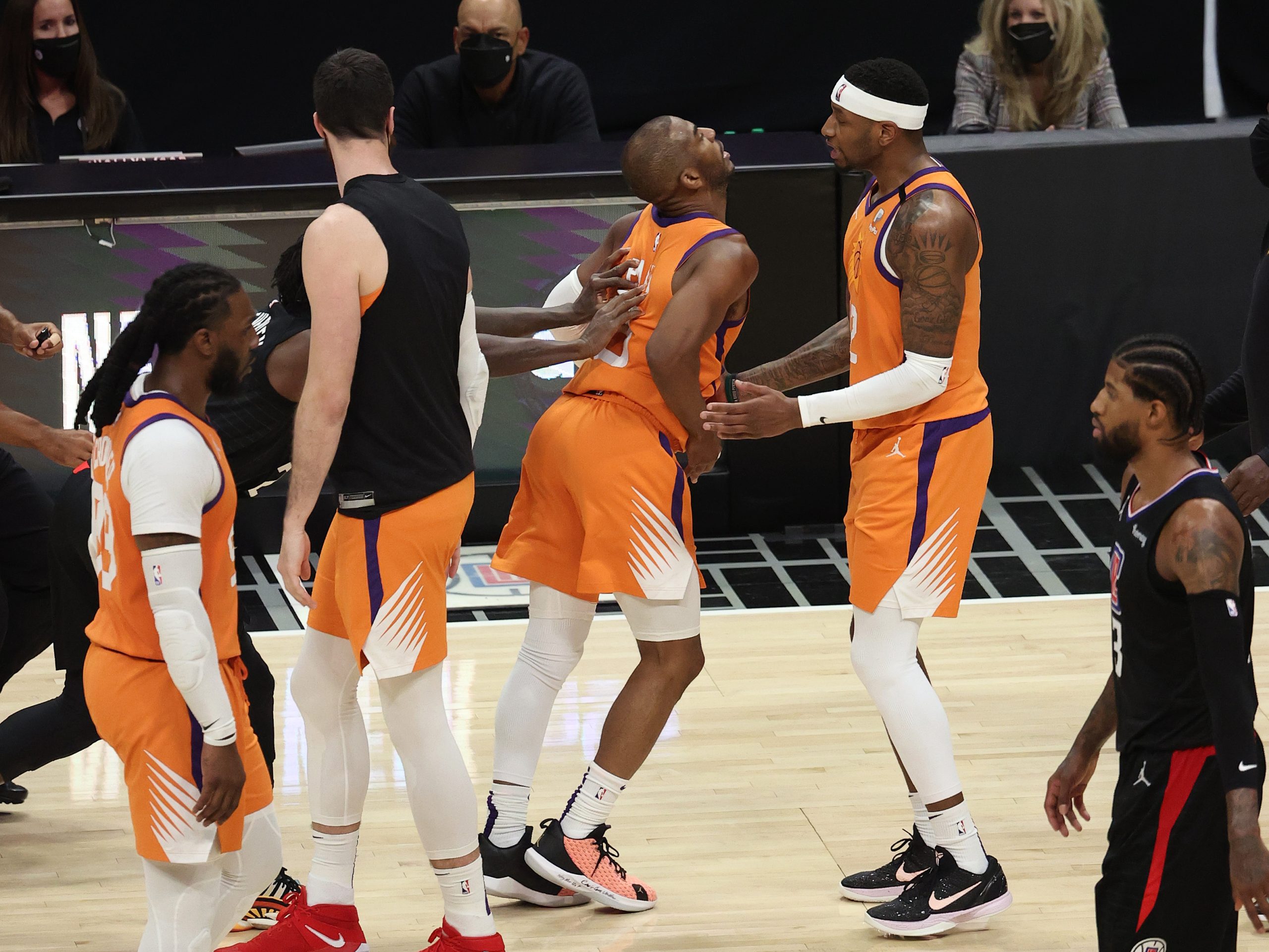 Patrick Beverley shoves Chris Paul from behind.