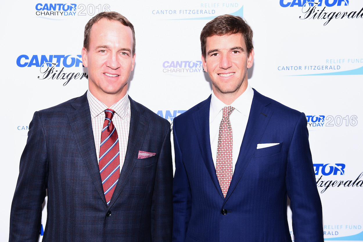 Former NFL players Peyton and Eli Manning attend the Annual Charity Day hosted by Cantor Fitzgerald, BGC and GFI at Cantor Fitzgerald on September 12, 2016 in New York City.