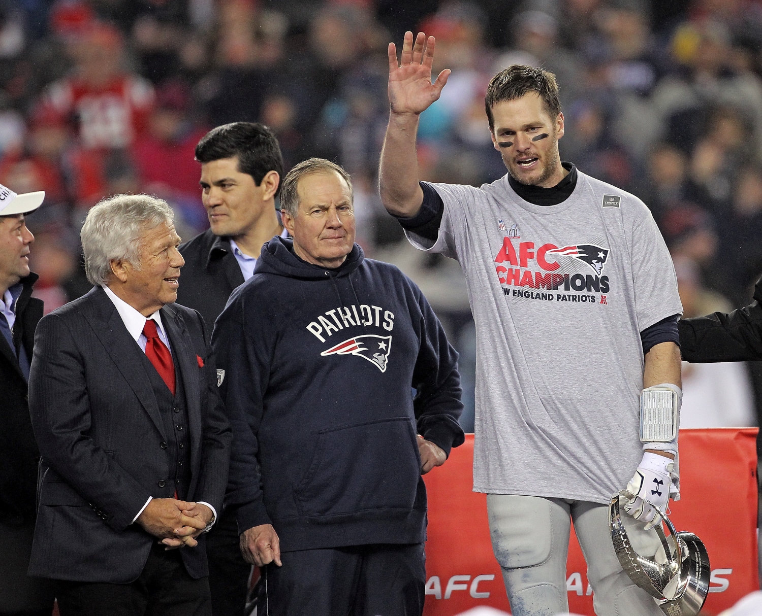 Robert Kraft, Bill Belichick, and Tom Brady stand on stage after the New England Patriots defeated the Pittsburgh Steelers in the AFC Championship.