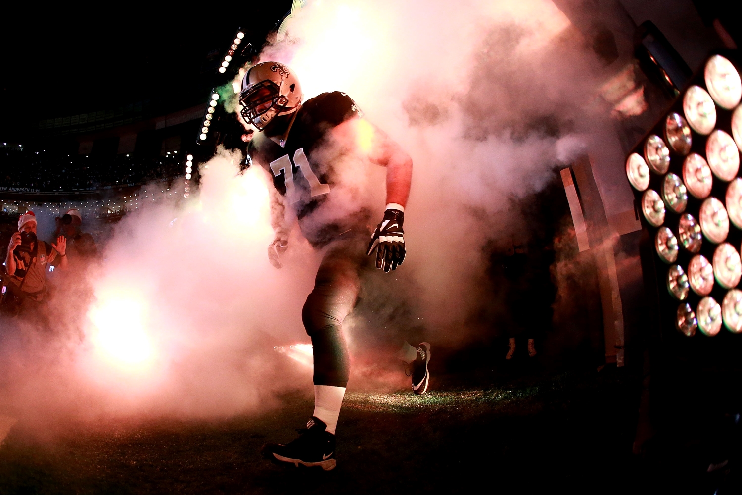 New Orleans Saints offensive lineman Ryan Ramczyk runs onto the field before a game.