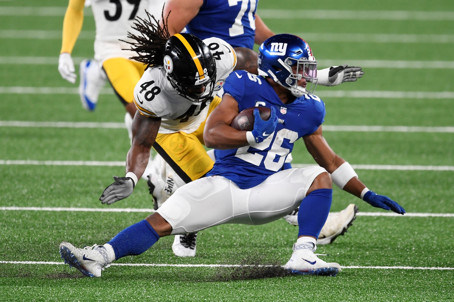 New York Giants running back Saquon Barkley gets tackled during a game against the Pittsburgh Steelers.