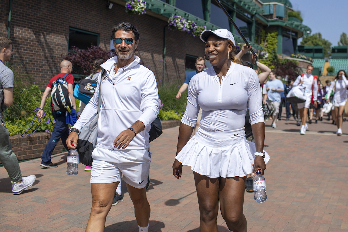 Serena Williams walks with coach Patrick Mouratoglou to the Wimbledon center court
