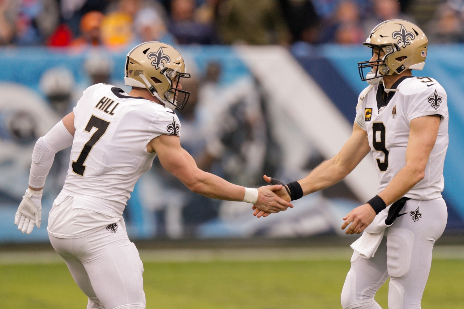 Taysom Hill shakes hands with New Orleans Saints teammate Drew Brees.