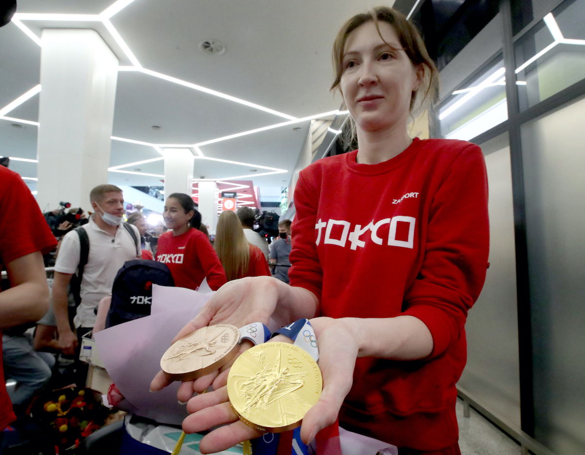 Olympic foil team champion/foil individual bronze medallist Larisa Korobeinikova shows her medals