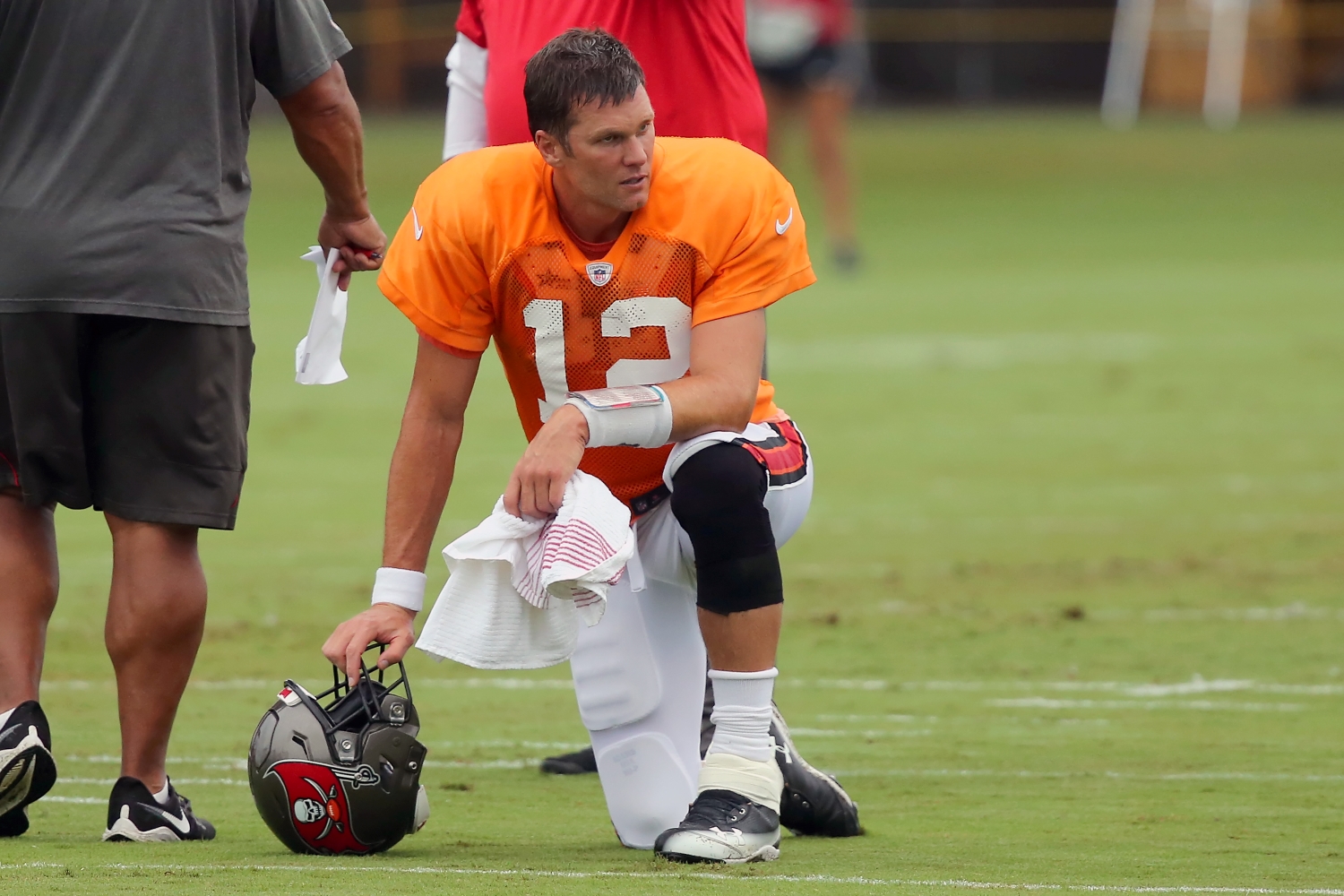 Tampa Bay Buccaneers quarterback Tom Brady takes a knee during training camp practice.