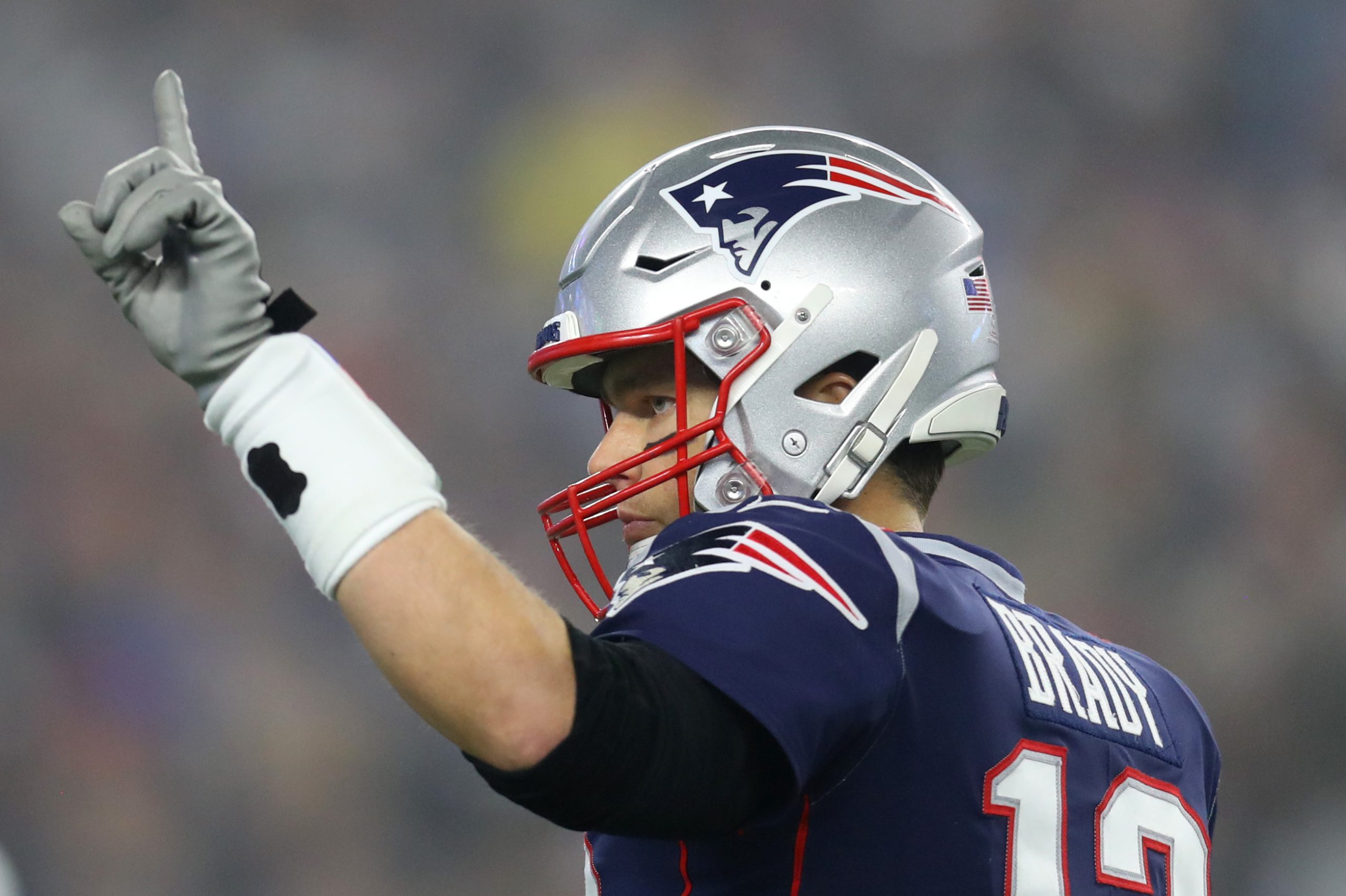 Tom Brady of the New England Patriots signals to teammates during the AFC Wild Card Playoff game against the Tennessee Titans.