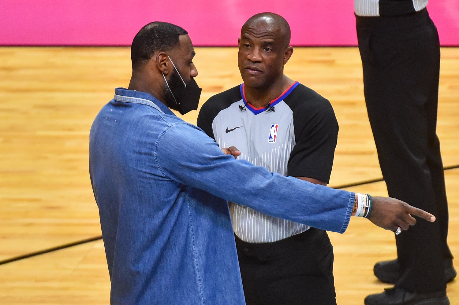LeBron James talks with referee Tony Brown during a timeout in the first half of the Los Angeles Lakers' game against the Miami Heat at American Airlines Arena on April 8, 2021.