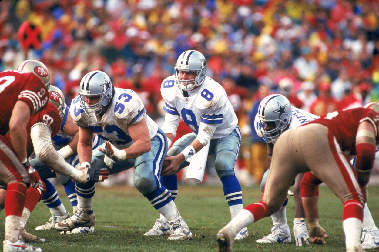 Quarterback Troy Aikman of the Dallas Cowboys takes the snap from center Mark Stepnoski #53 against the San Francisco 49ers in the 1992 NFC Championship Game at Candlestick Park on January 17, 1993 in San Francisco, California.