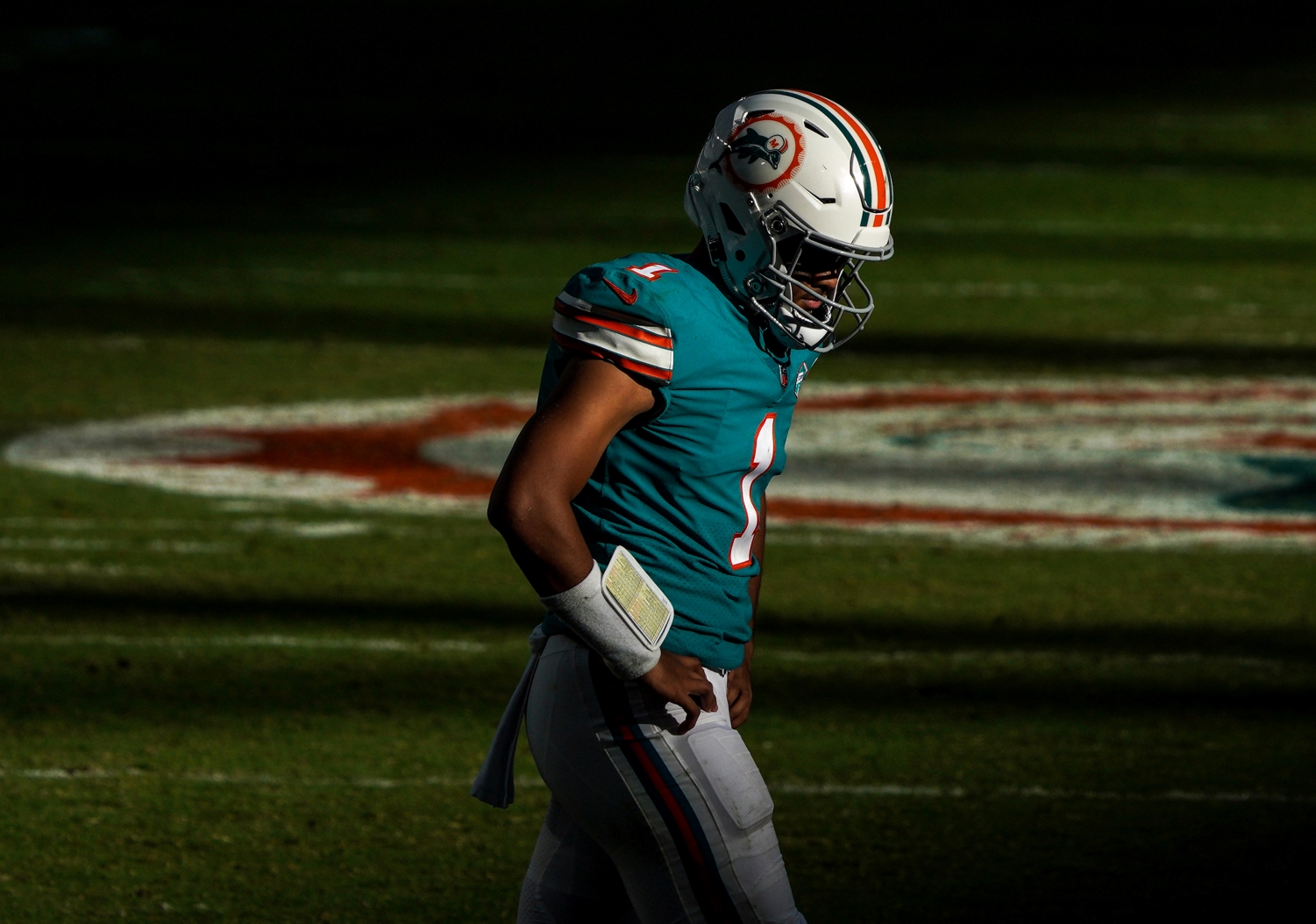 Miami Dolphins quarterback Tua Tagovailoa walking off the field.