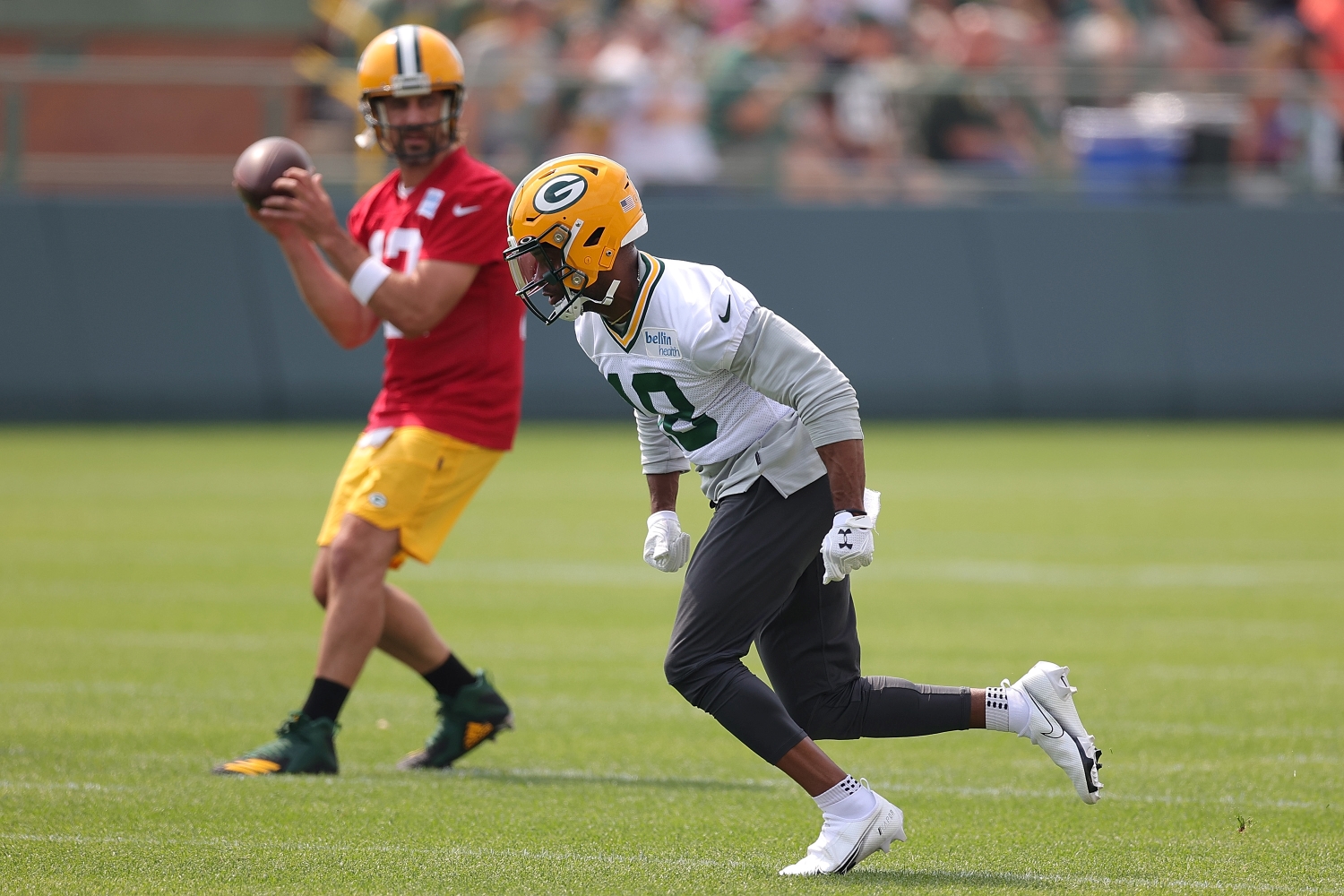 Green Bay Packers wide receiver Randall Cobb runs a route as Aaron Rodgers prepares to throw a pass.