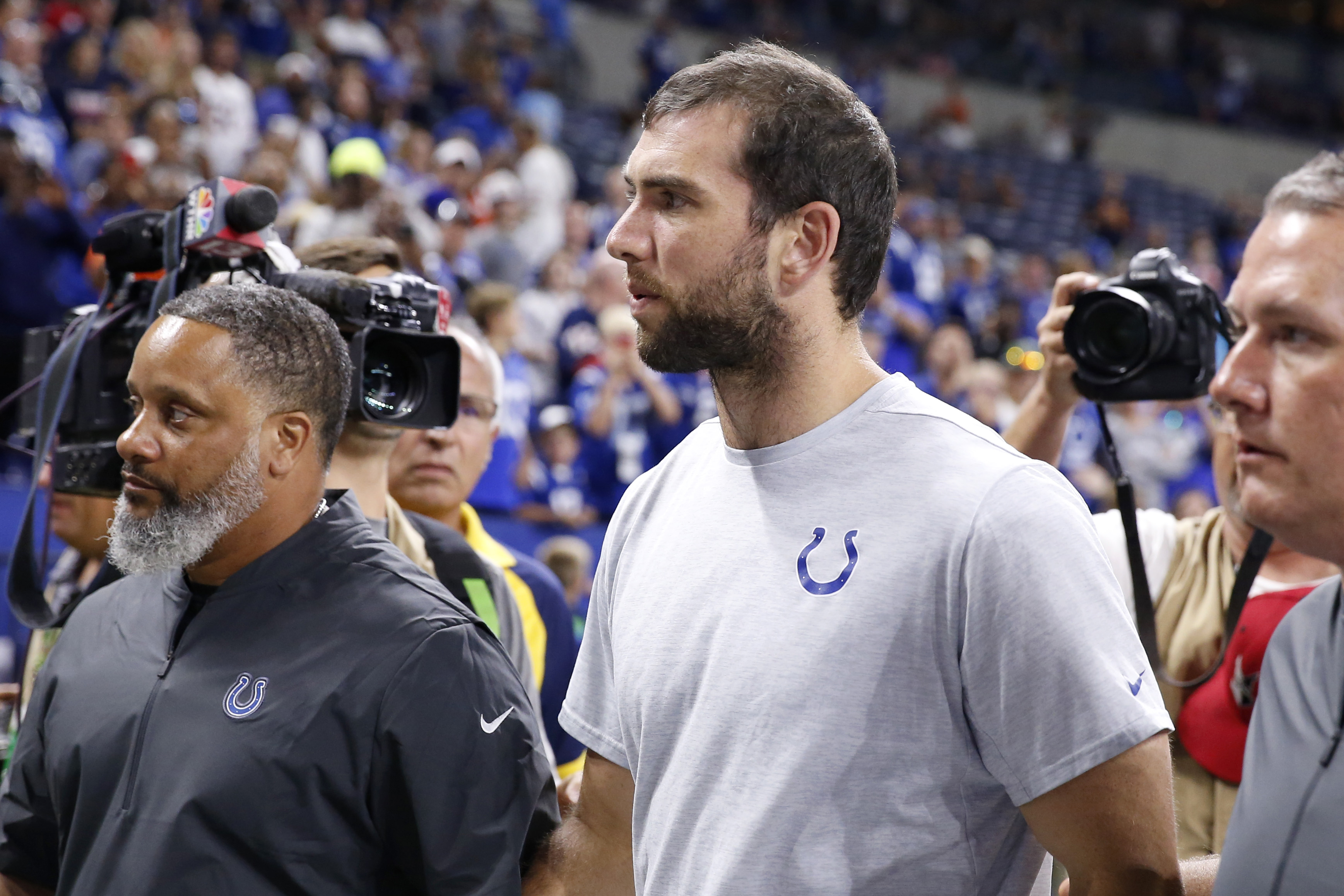 Former Colts quarterback Andrew Luck walks off the field after it was reported he would be retiring from the NFL