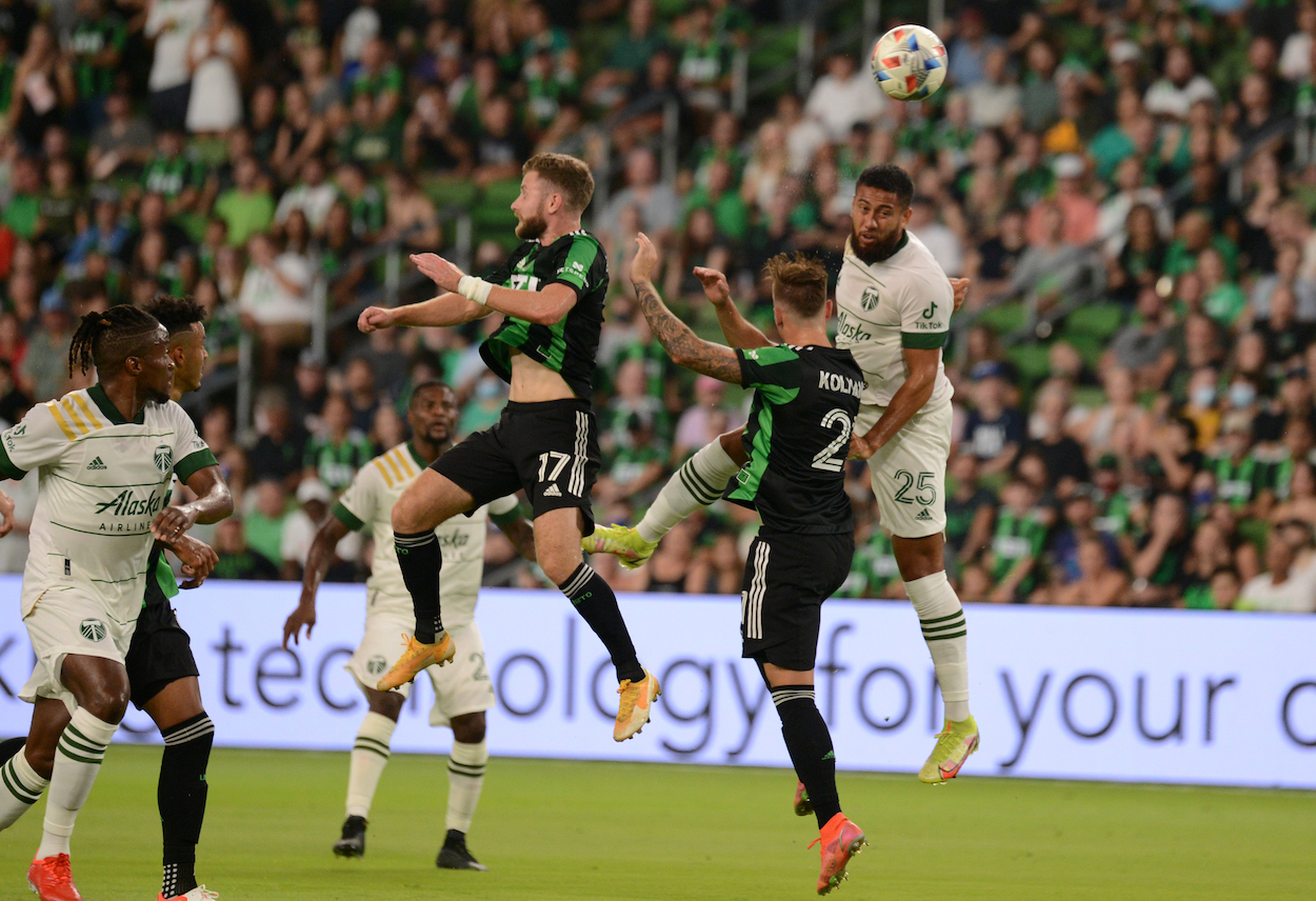 Austin FC players and Portland Timbers players battle for ball