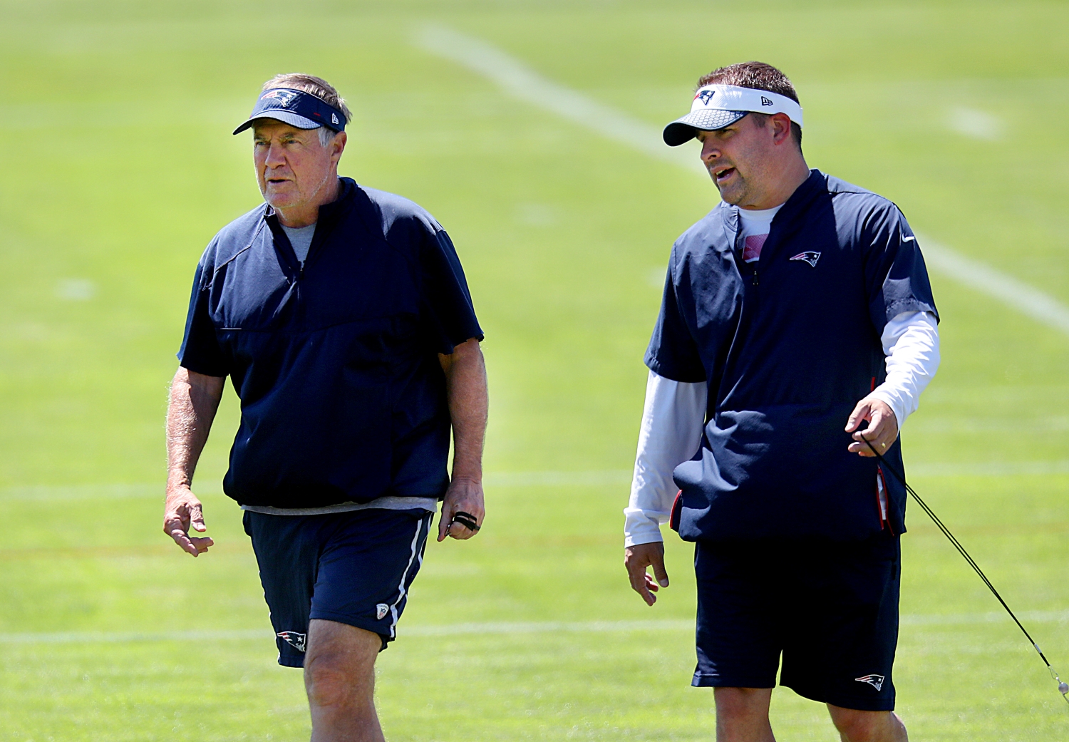 New England Patriots head coach Bill Belichick speaks to offensive coordinator Josh McDaniels during practice.