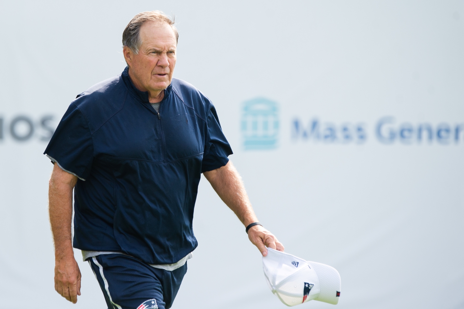 New England Patriots head coach Bill Belichick walks onto the field ahead of training camp.