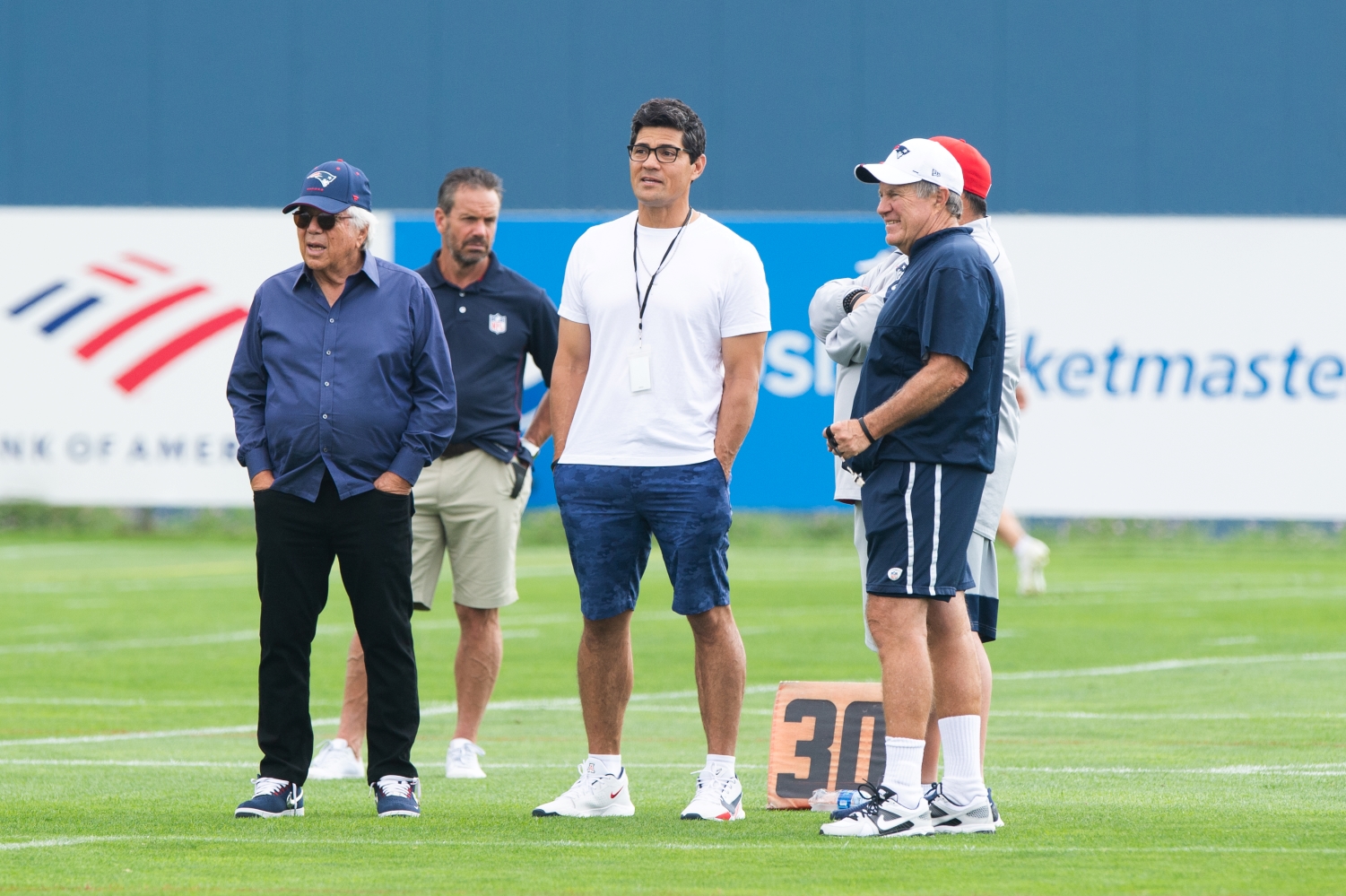 New England Patriots owner Robert Kraft, former player Tedy Bruschi, senior football advisor Matt Patricia, and head coach Bill Belichick stand together during training camp practice.