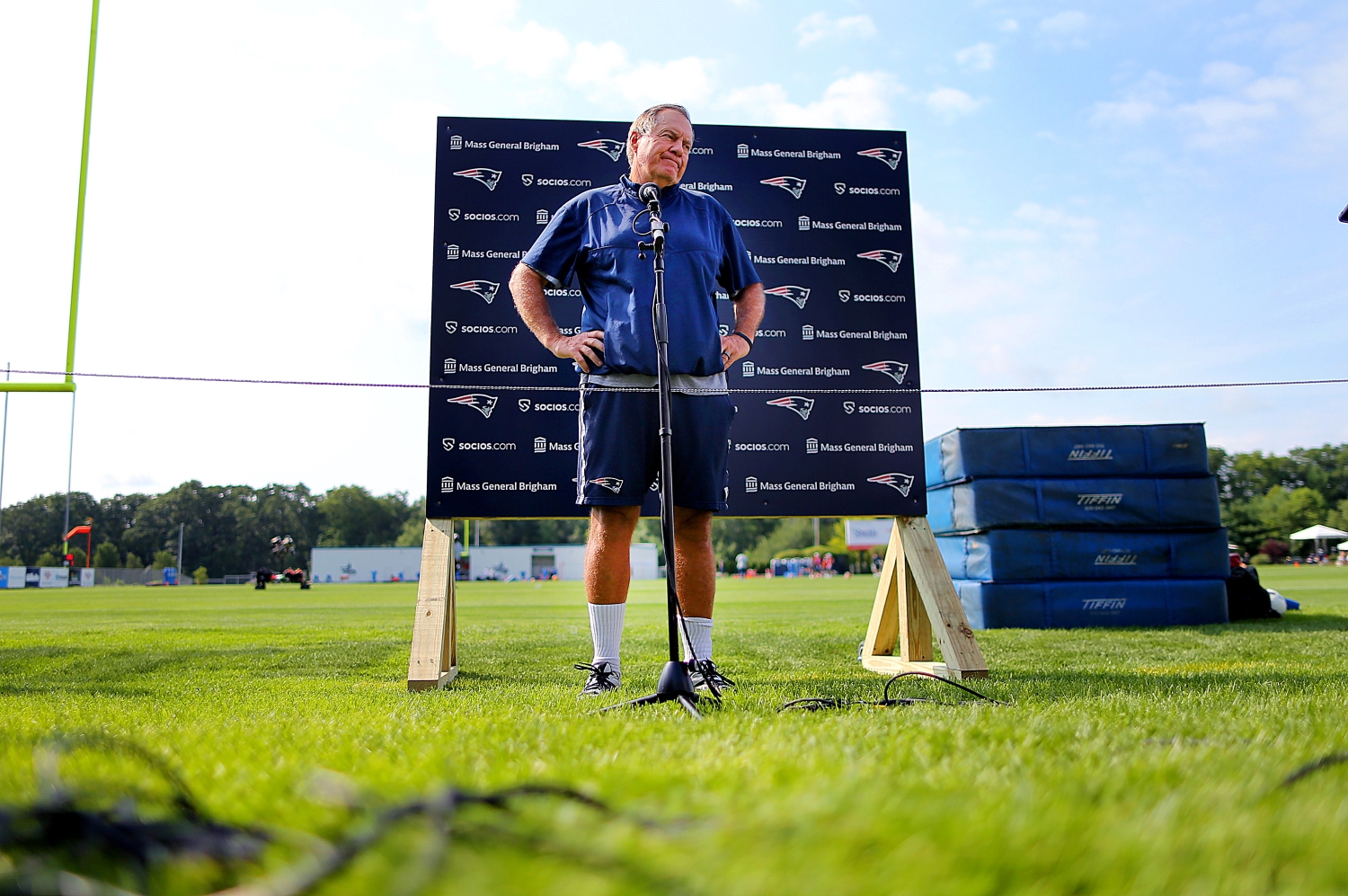 New England Patriots head coach Bill Belichick speaks to reporters during training camp.