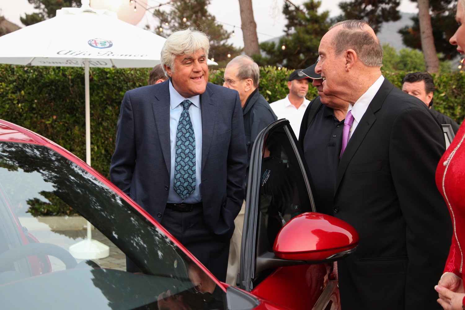 Jay Leno and Bob Bondurant check out the 2017 Alfa Romeo Giulia at Folktale Winery on Aug. 19, 2016, in Carmel, California.  | Kelly Sullivan/Getty Images for The Hollywood Reporter