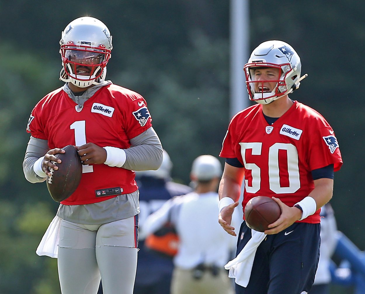 Cam Newton and Mac Jones prepare to throw during New England Patriots training camp