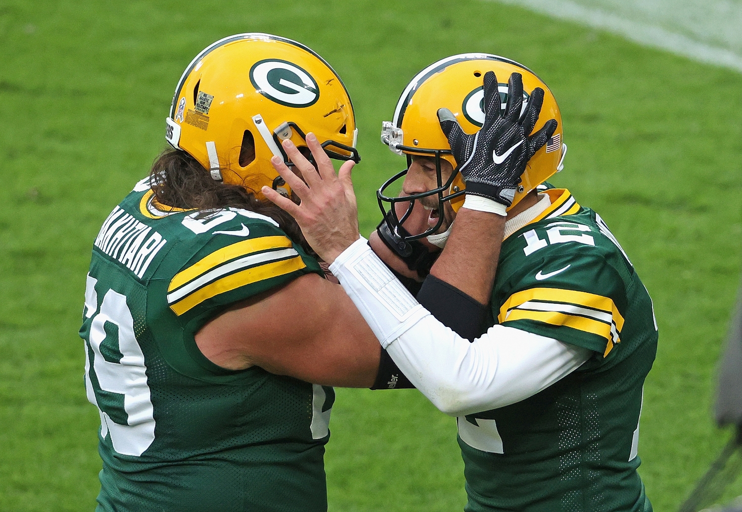 Green Bay Packers teammates David Bakhtiari and Aaron Rodgers celebrate scoring a touchdown.