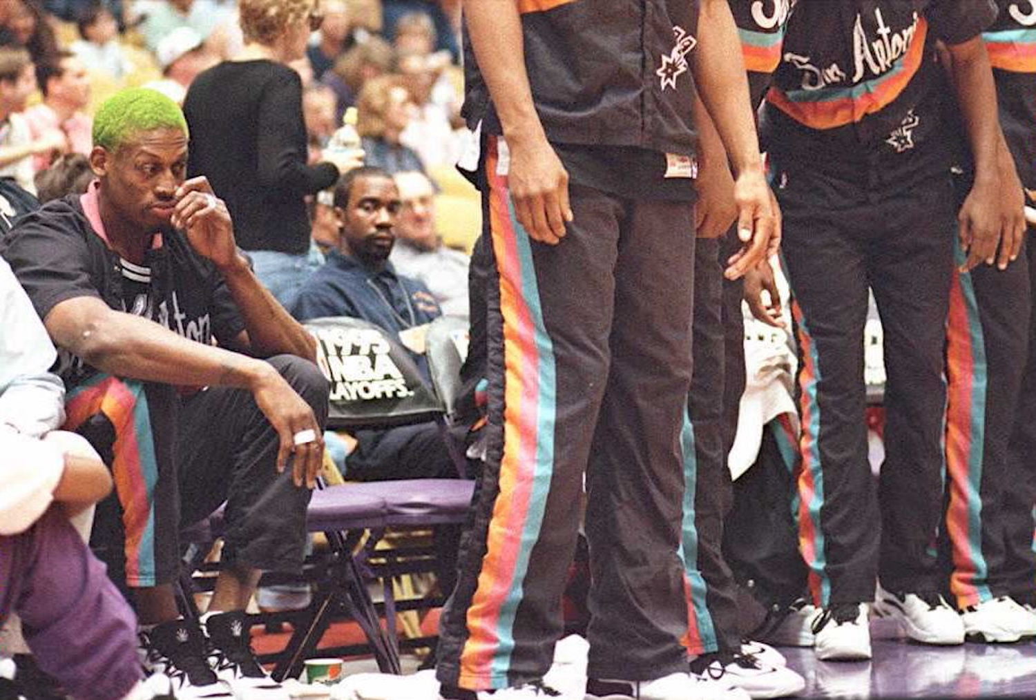Dennis Rodman sits behind his San Antonio Spurs teammates.