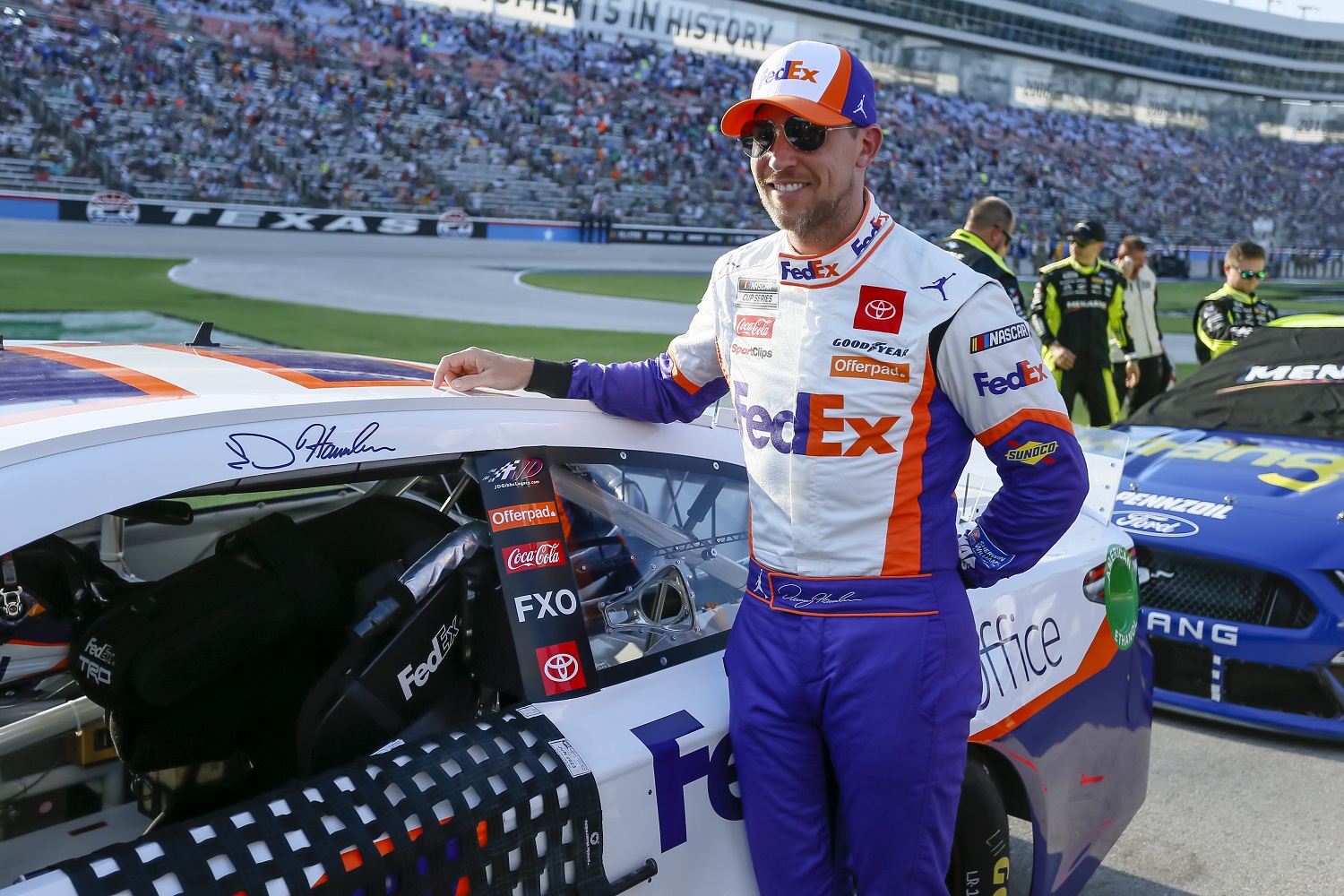 Denny Hamlin stands next to his car before the NASCAR Cup Series All-Star Race on June 13, 2021, at Texas Motor Speedway.